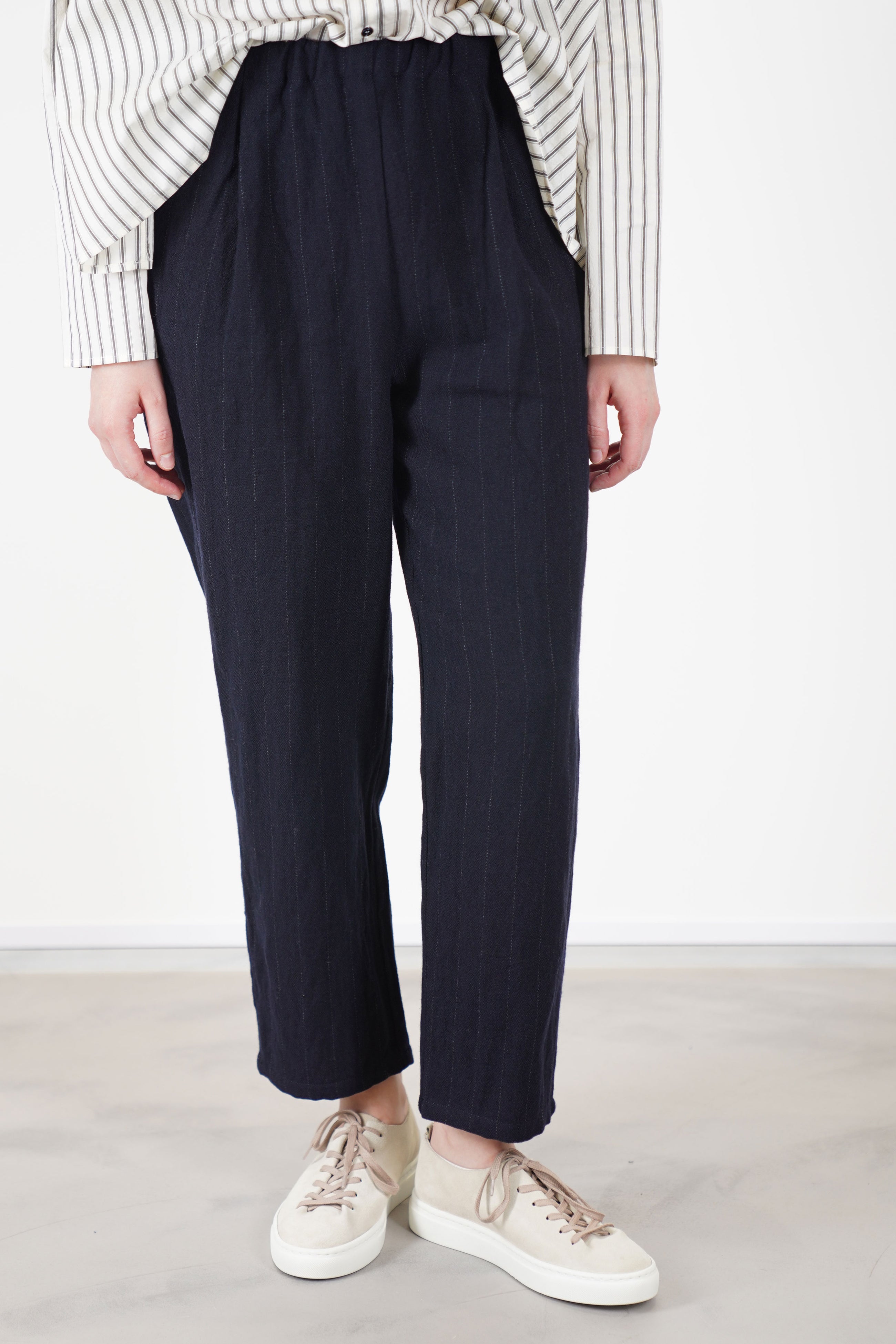 apuntob (a.b) woolen trousers blue thin stripes featuring an elastic waistband, a relaxed fit with a tapered leg, and a slightly cropped length