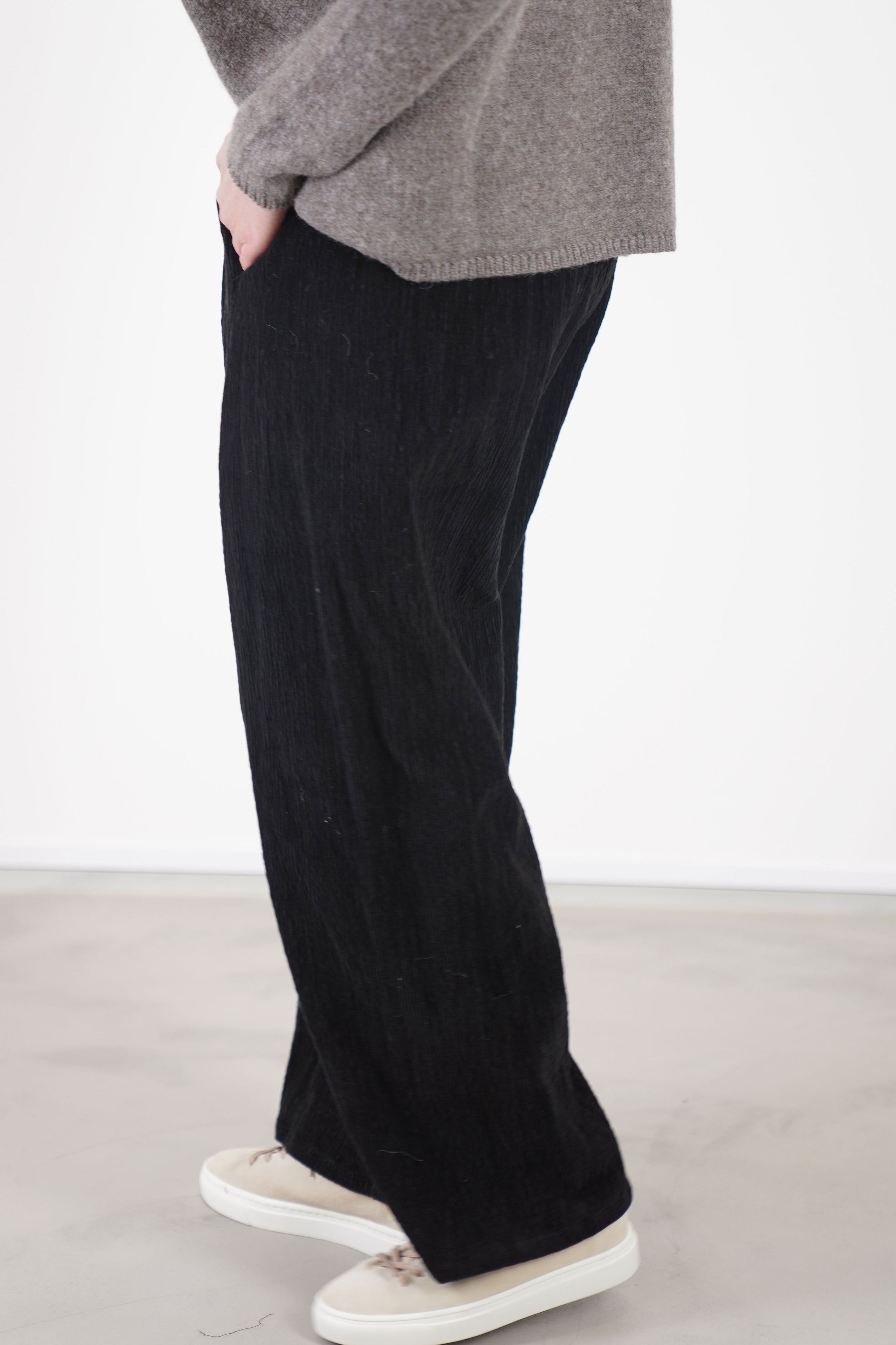 side view of apuntob (a.b) trousers cord black comfortable, relaxed style