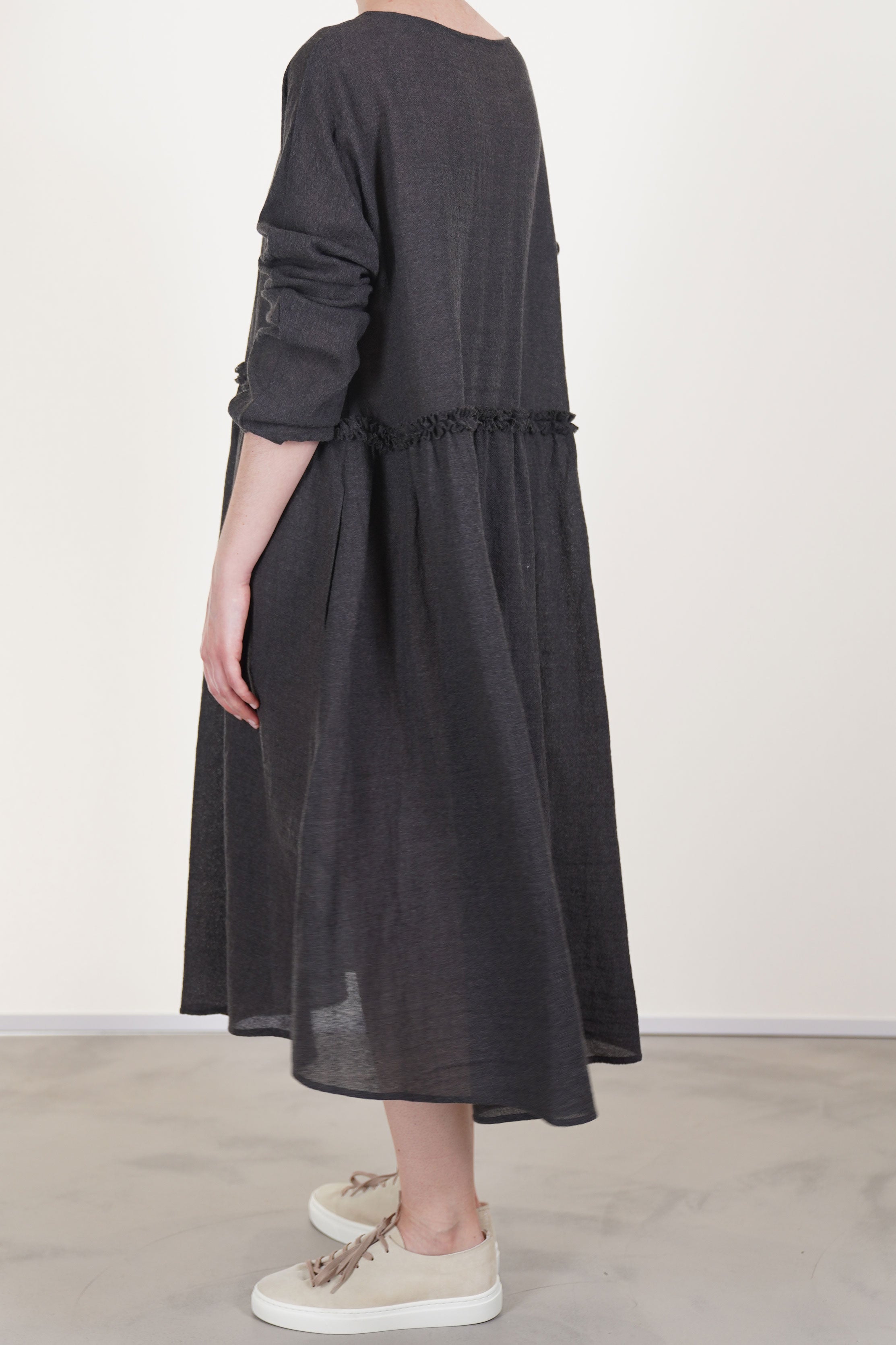 back view of apuntob (a.b) dress wool asphalt grey relaxed cut and flowy skirt detail