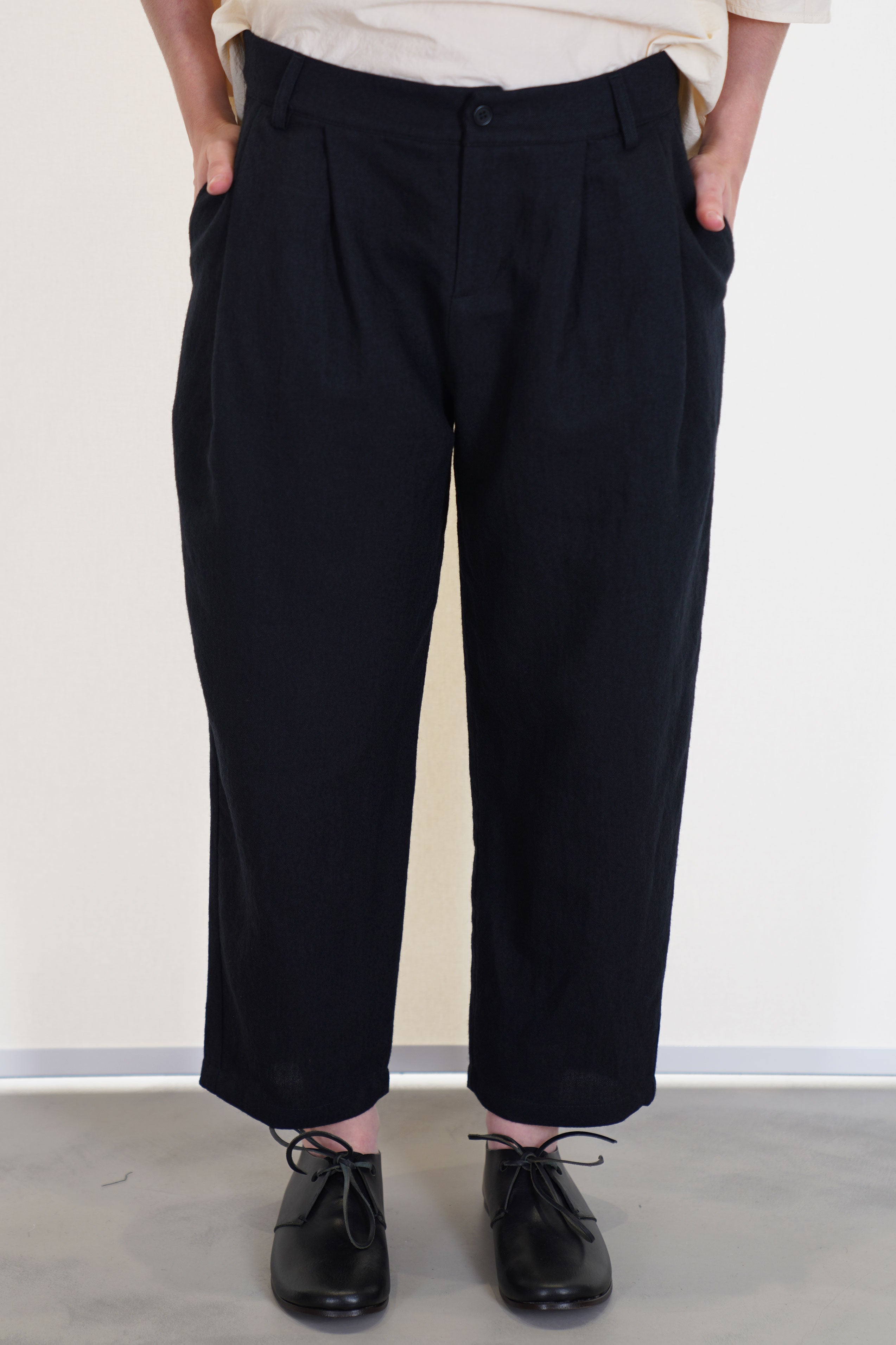 front view of apuntob (a.b) trousers black side pockets and a tapered leg. unlined.