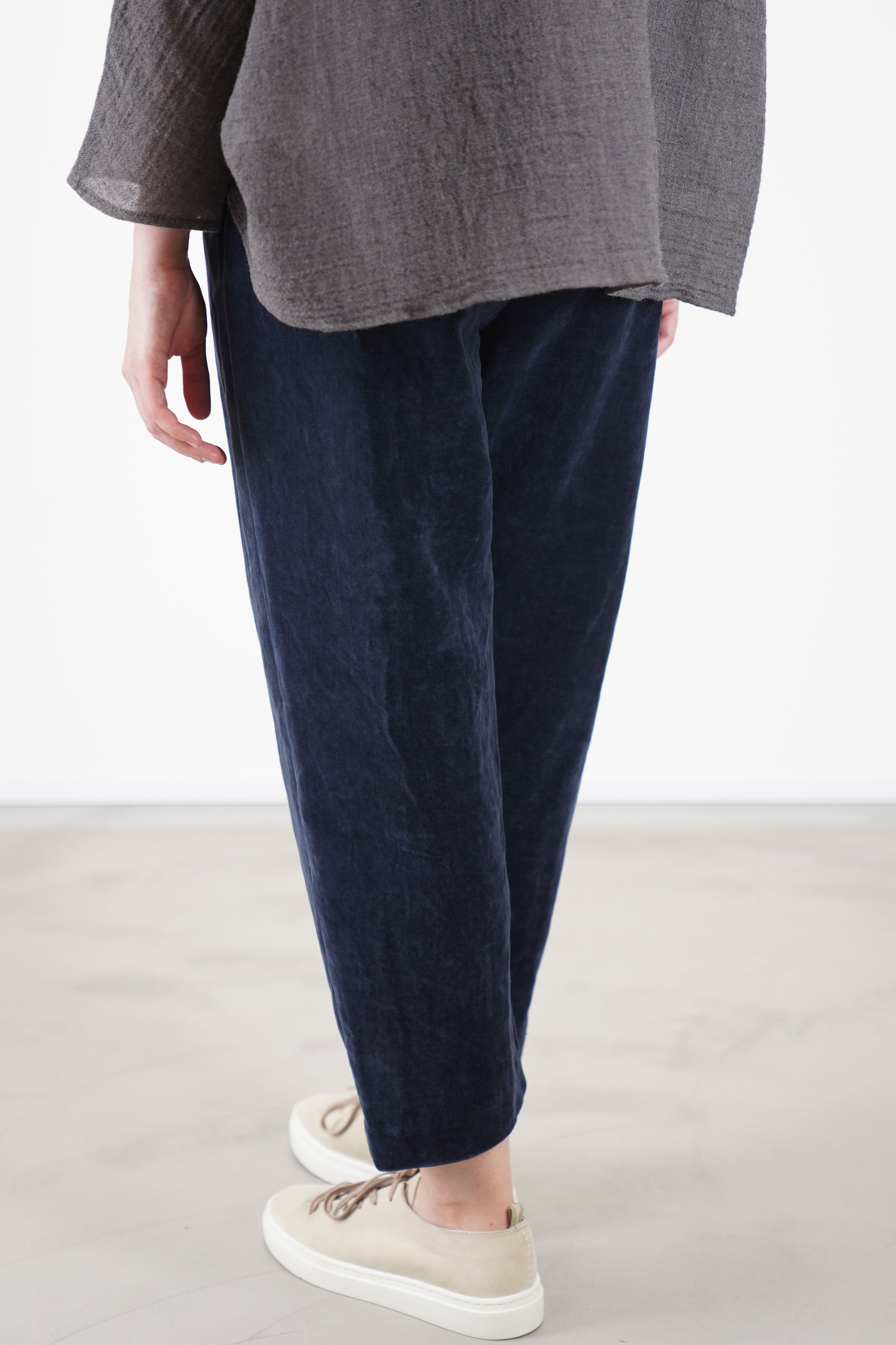 back view of apuntob (a.b) velvet trousers blue relaxed tapered leg making them ideal for stylish everyday wear with effortless ease.