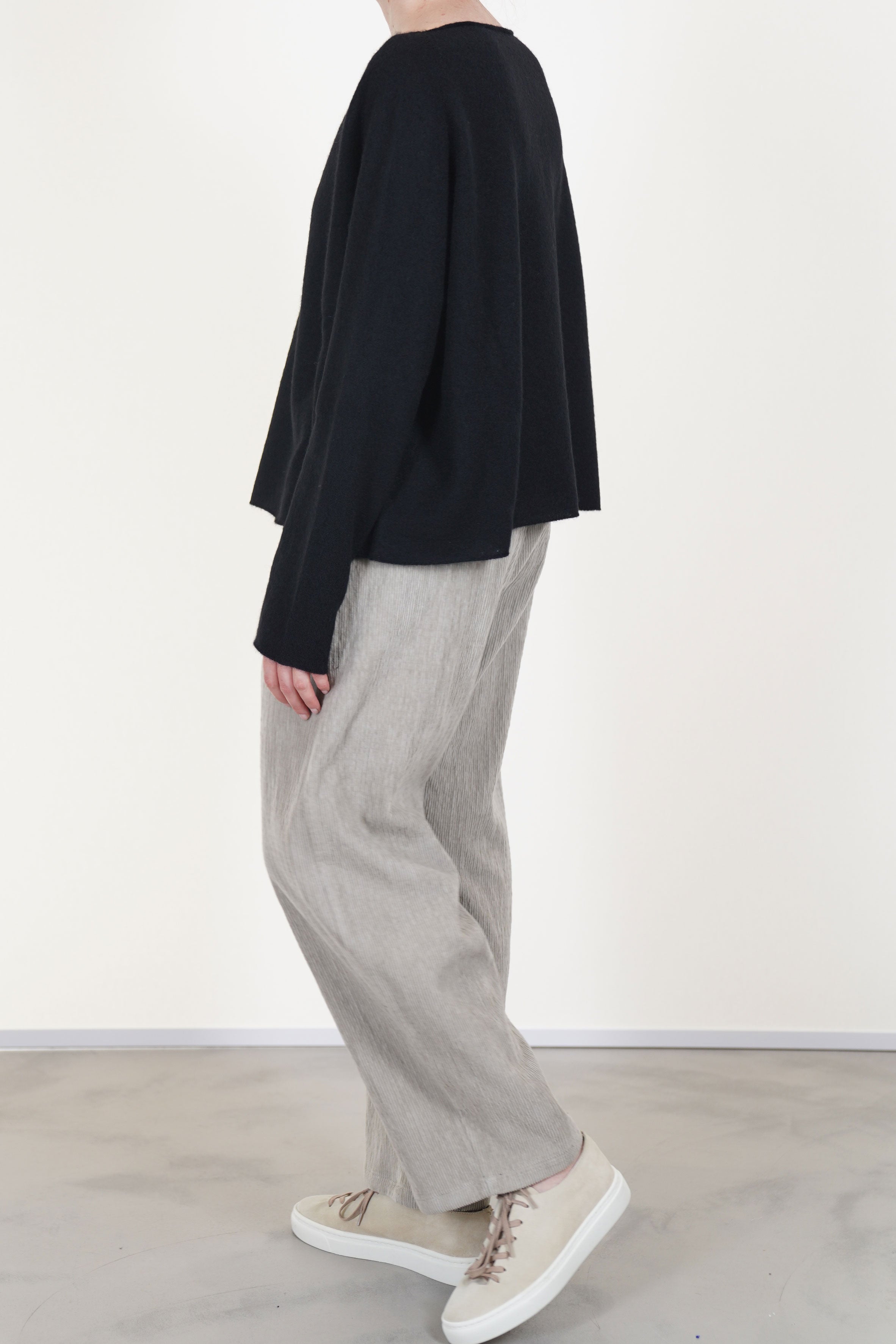 profile view of apuntob (a.b) wool silk knitwear black islightly cropped length combined with a wide cut that offers a relaxed fit.