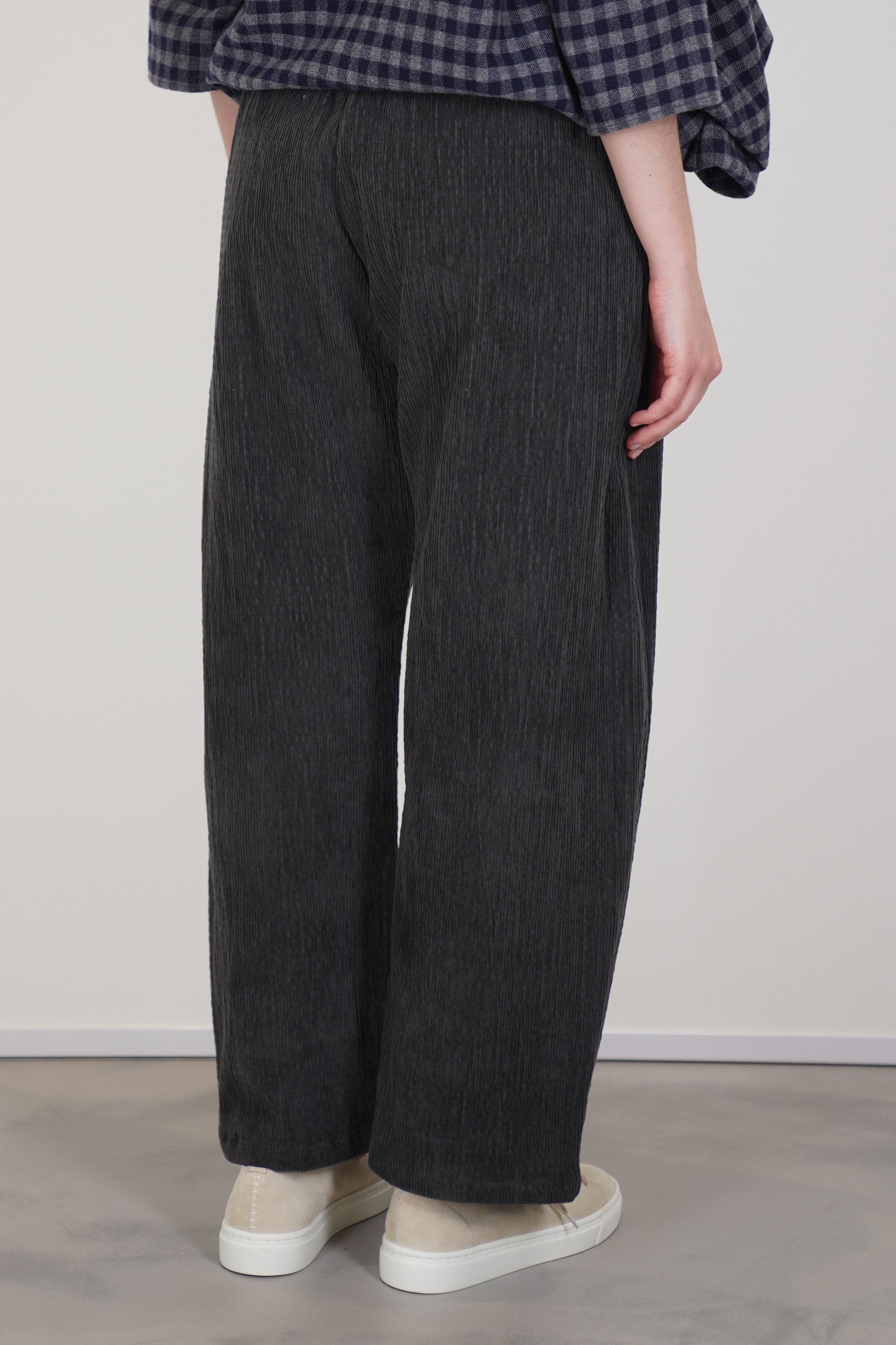 back view of apuntob (a.b) trousers cord stonewith a curved leg detail and ankle length