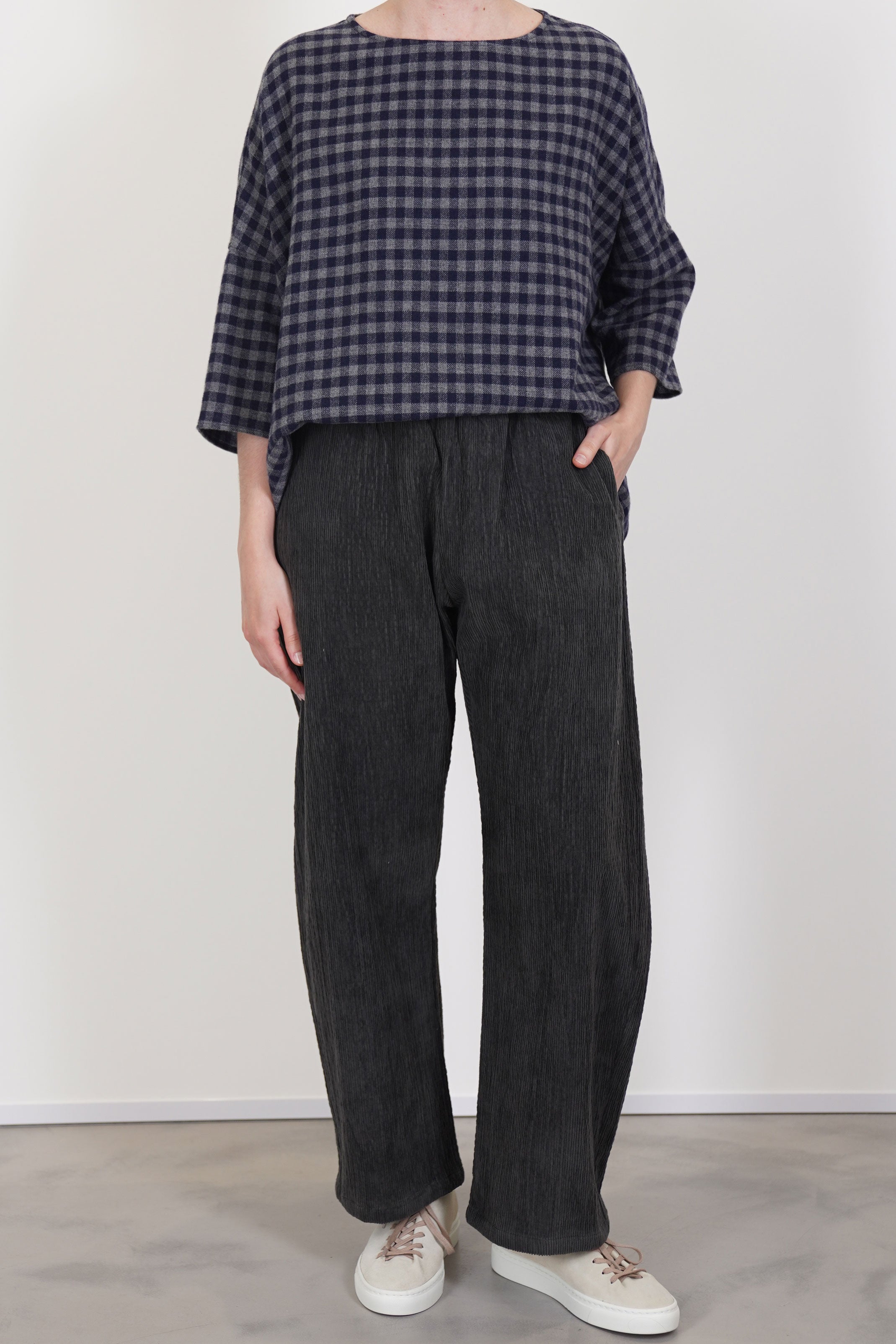 front view of apuntob (a.b) trousers cord stone featuring an elasticated waistband for a flexible, secure fit and a curved leg design