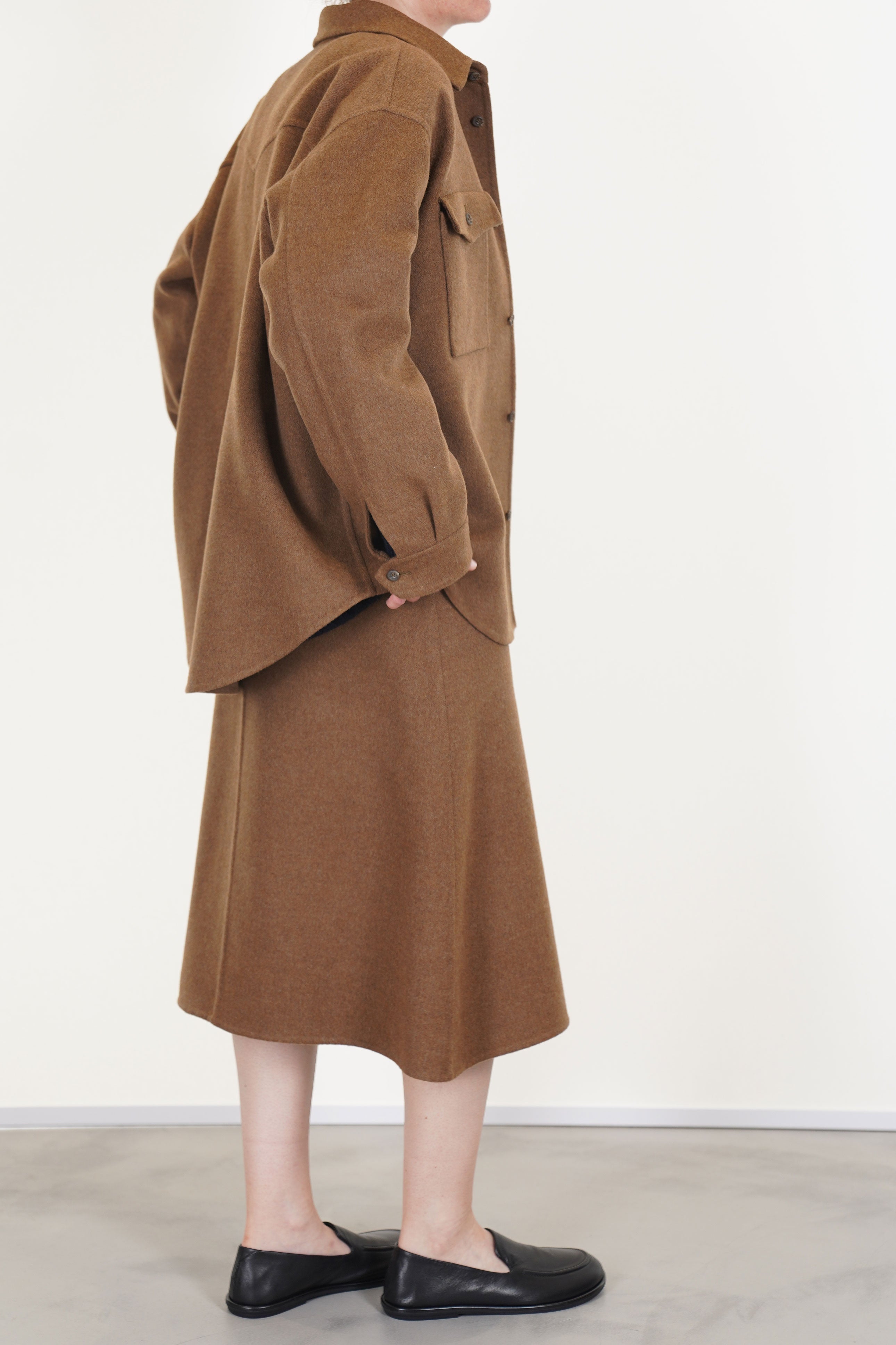 profile view of asciari ariel skirt wool cashmere brown showcases an a-line design with a narrow fit waist