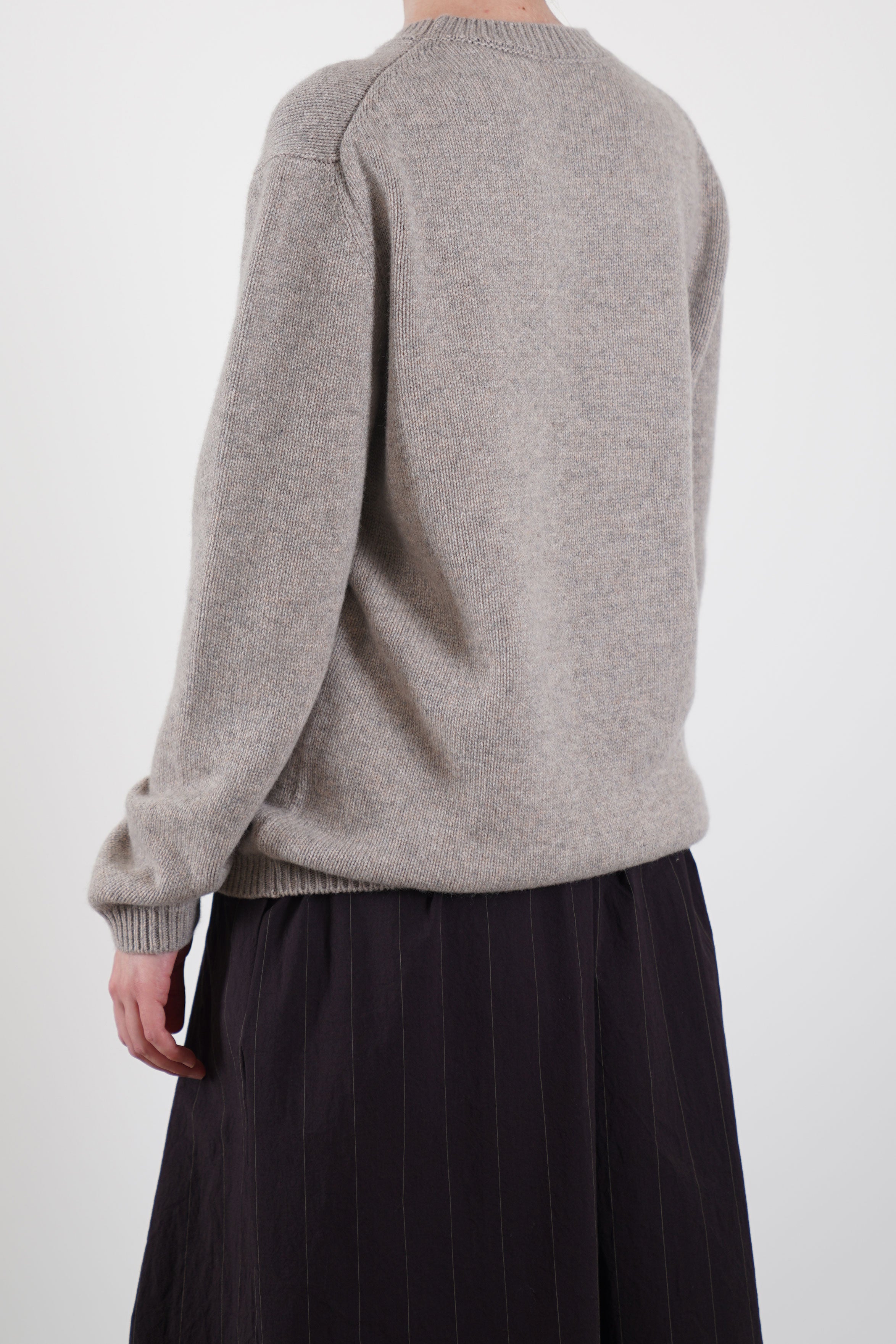 back view of bergfabel cashmere pullover greige relaxed, loose silhouette with drop shoulder design and detailed ribbing for added texture.