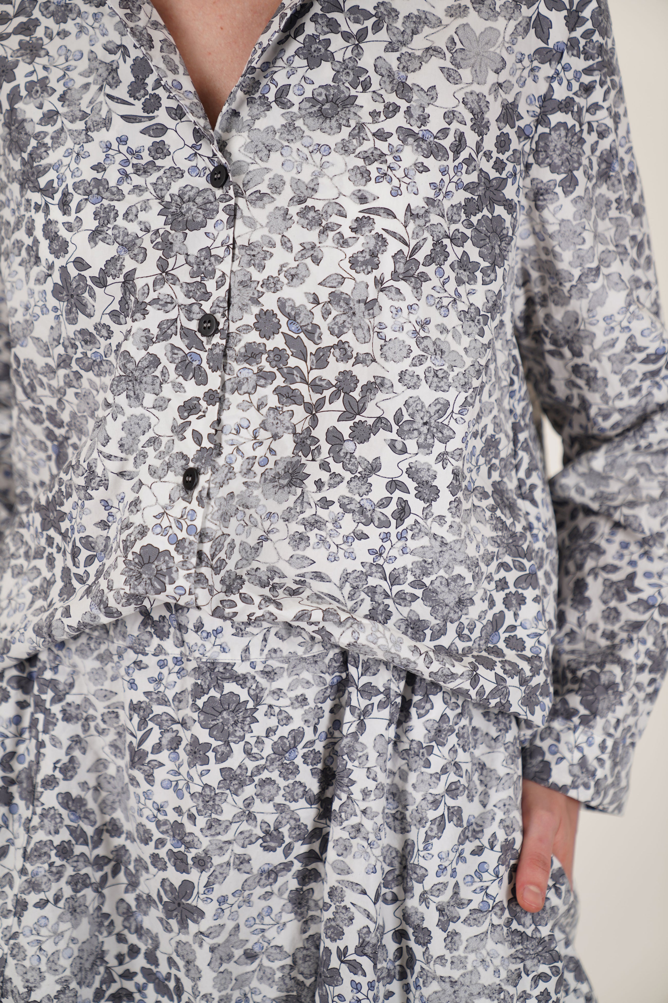 detail view of bergfabel jenny shirt bright flowers tonal front buttons and a v-neckline accented by a notched collar detail.