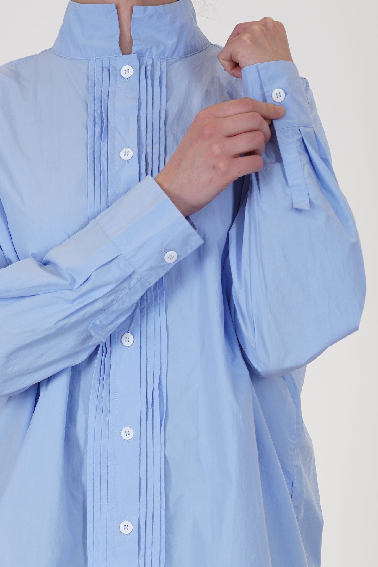 detail view of bergfabel claudia long shirt powder blue pleat details and button opening at the cuffs
