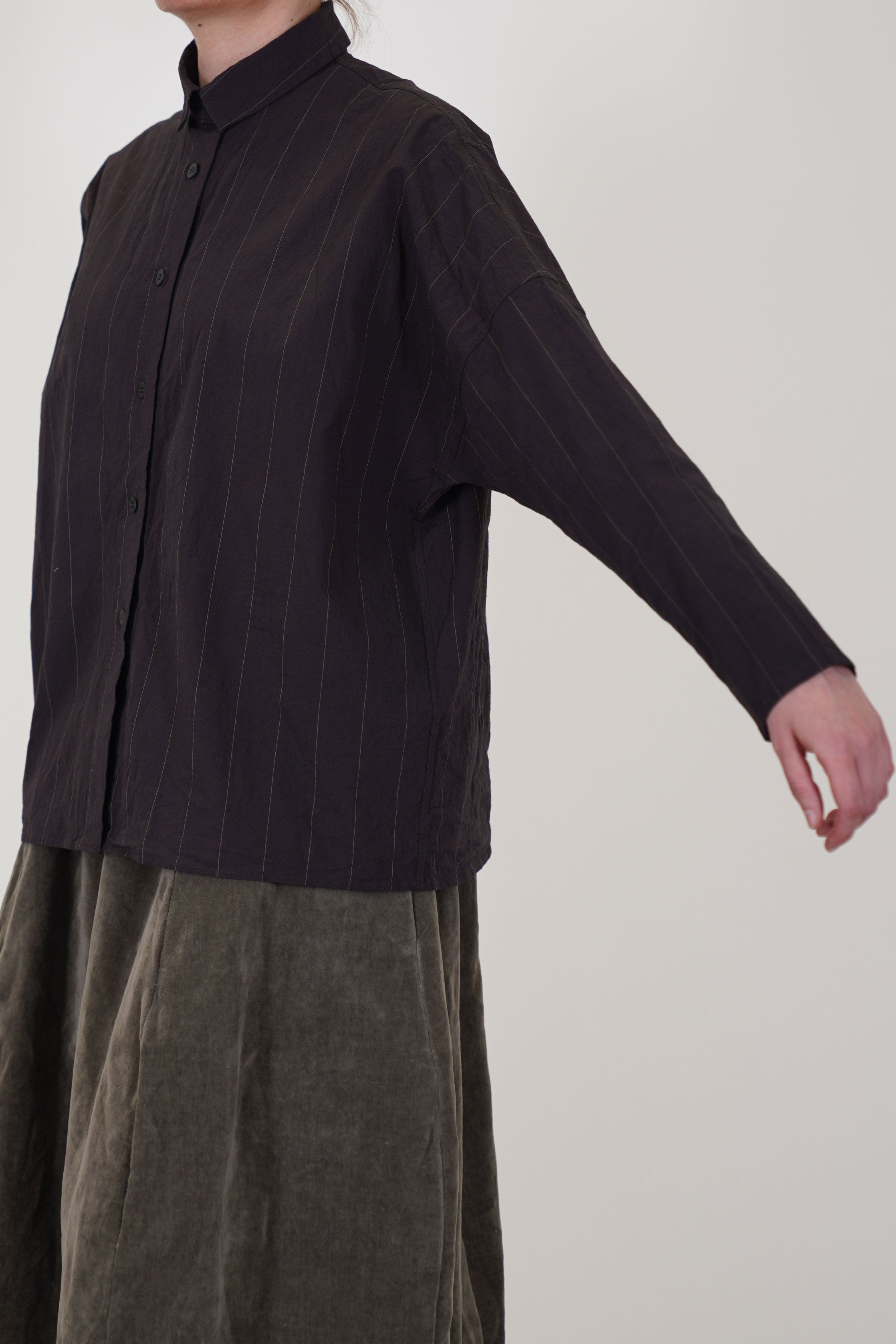 side view of bergfabel tina shirt eggplant featuring thin pinstripe details, a boxy cut with a classic collar
