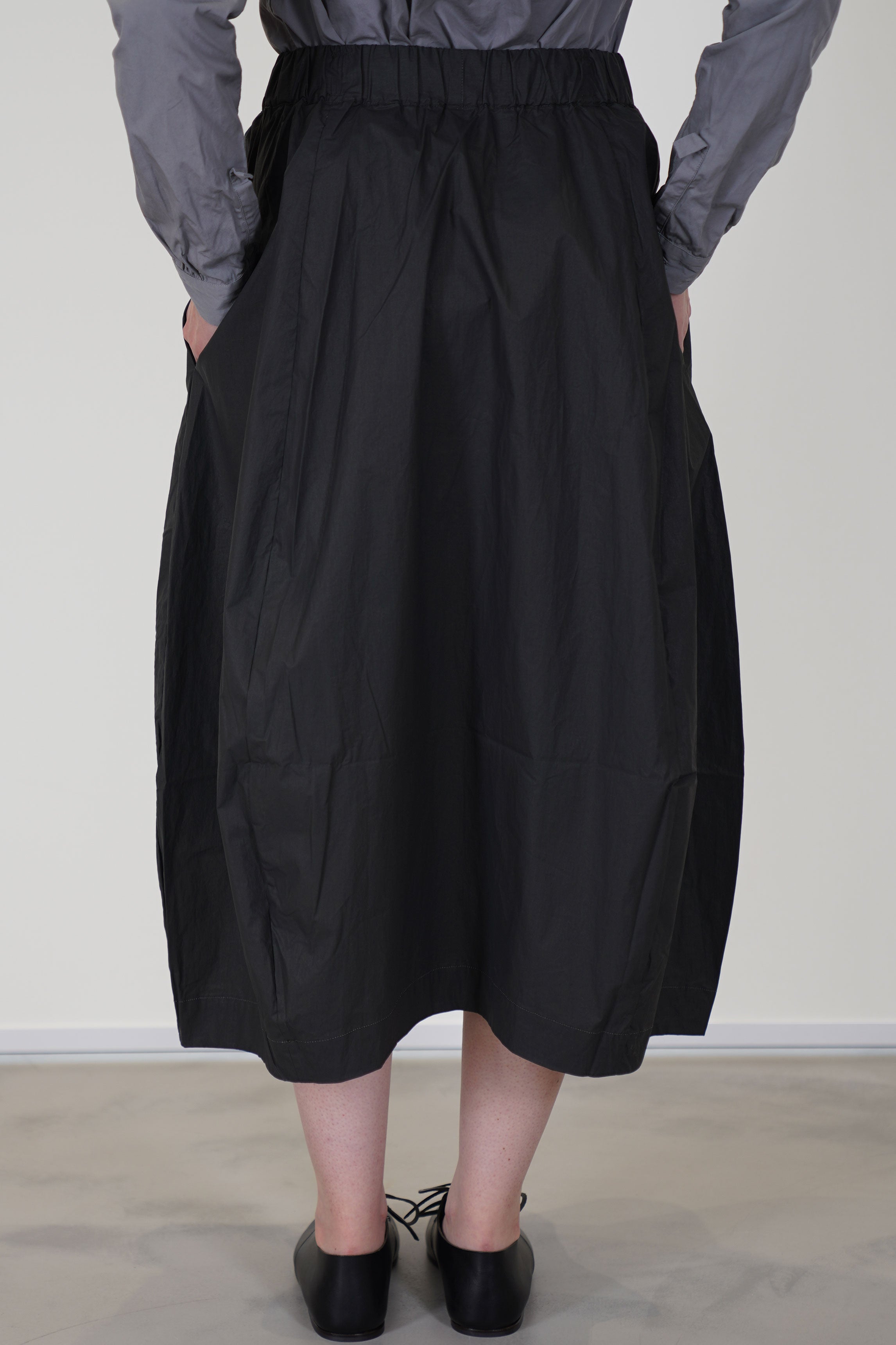 back view of bergfabel coated cotton carla skirt carbon elasticated waistband, voluminous fit and balloon style skirt