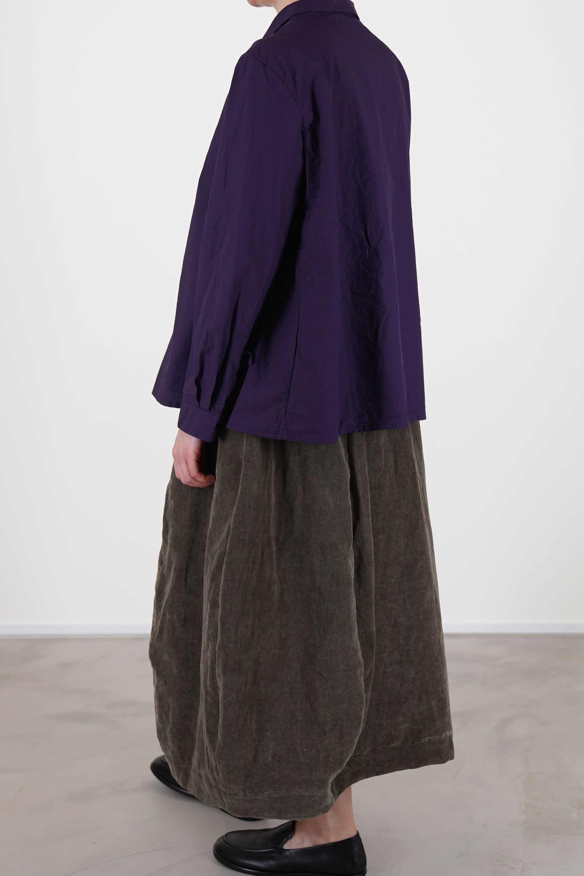 profile view of bergfabel jenny shirt acai worn with carla skirt velvet mud