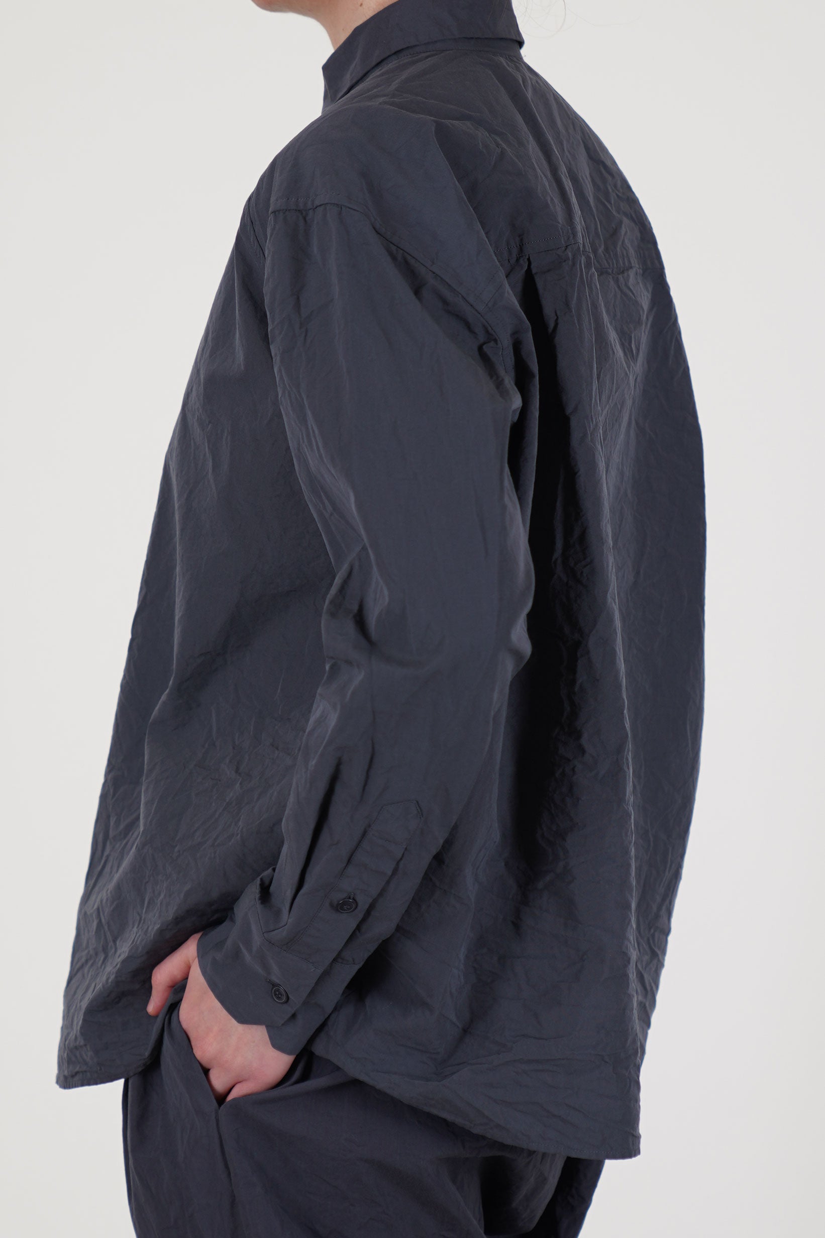 back view of casey casey drays shirt blu skull  its dropped shoulders offer a loose, flowing shape that suits both layered looks and standalone wear.