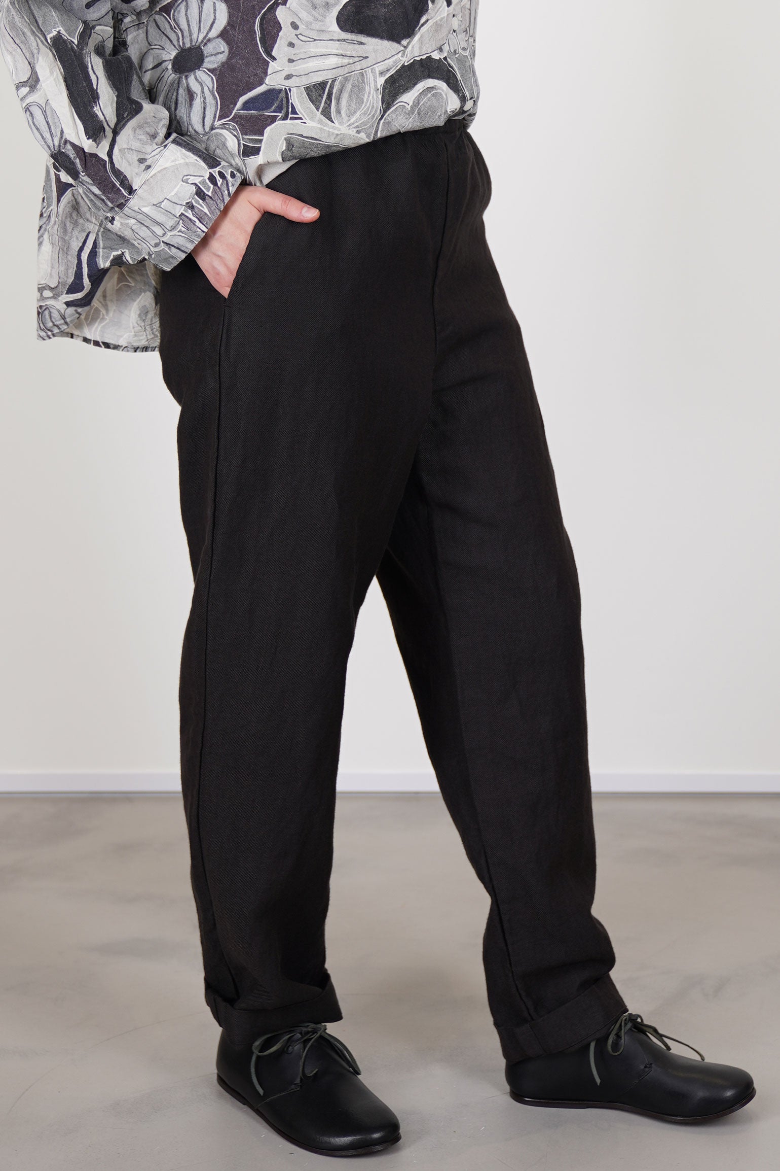 side view of casey casey long chasse pants dark brown long striaght legs and side pocket details.