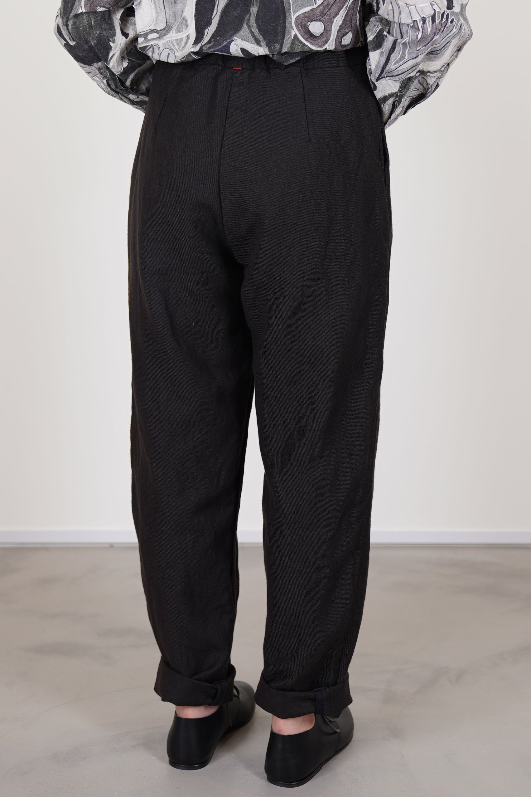 back view of casey casey long chasse pants dark brown long striaght legs and signature red string detail