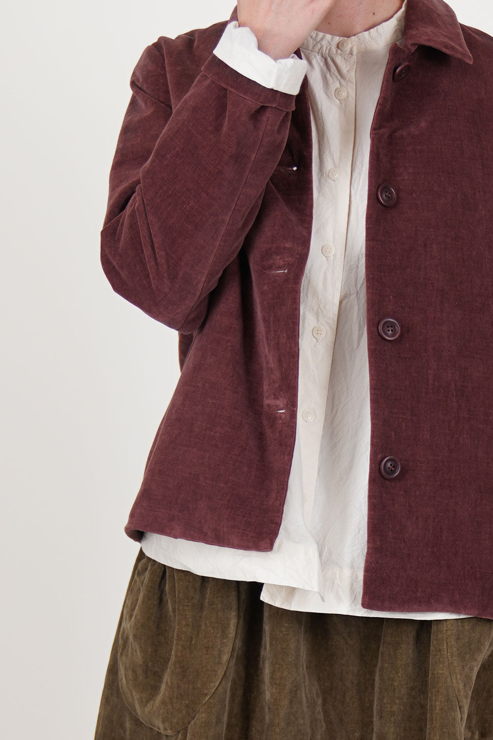 detail view of casey casey pwet jacket velvet prune front button opening and corozo button details