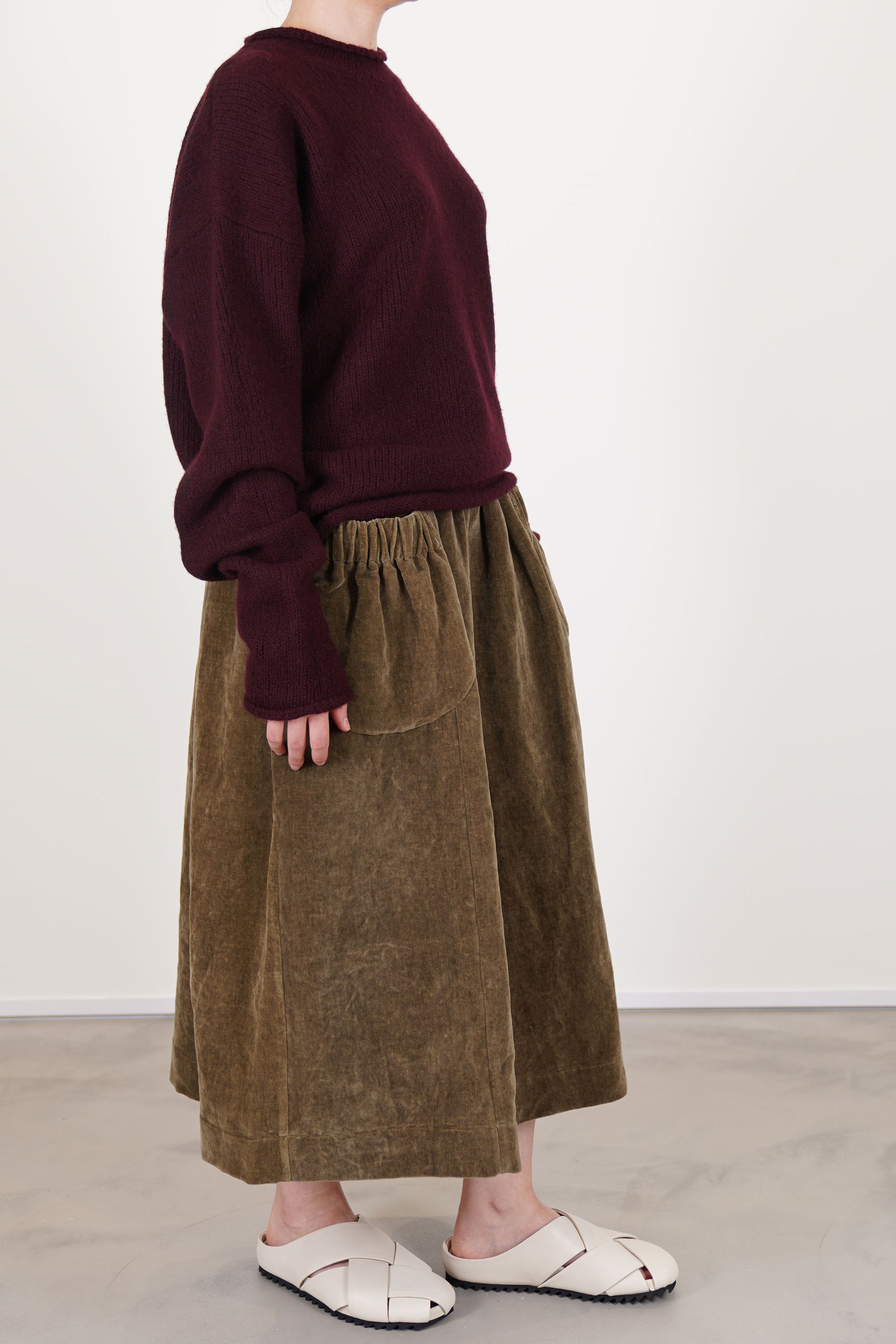 side view of casey casey softy jumper prune featuring a classic round neckline and finished with rolled edges at the collar, cuffs, and hem