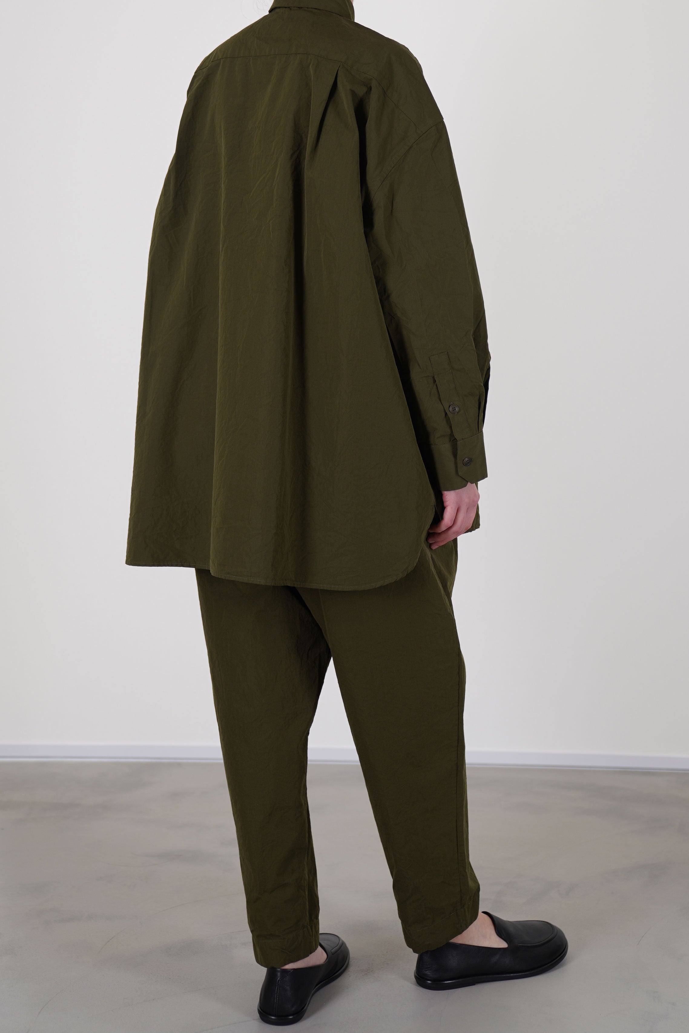 casey casey hamnet shirt green lake oft, structured shirt contrasts beautifully with the relaxed silhouette of the pants, offering a modern balance of color and shape.