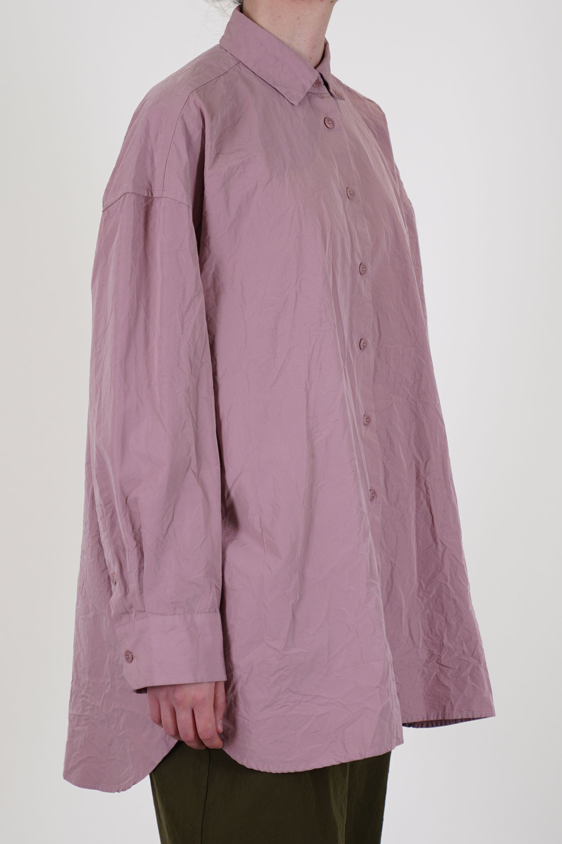 side view of casey casey hamnet shirt pink  long sleeve, curved hemline and an elongated back for a relaxed and loose fit.