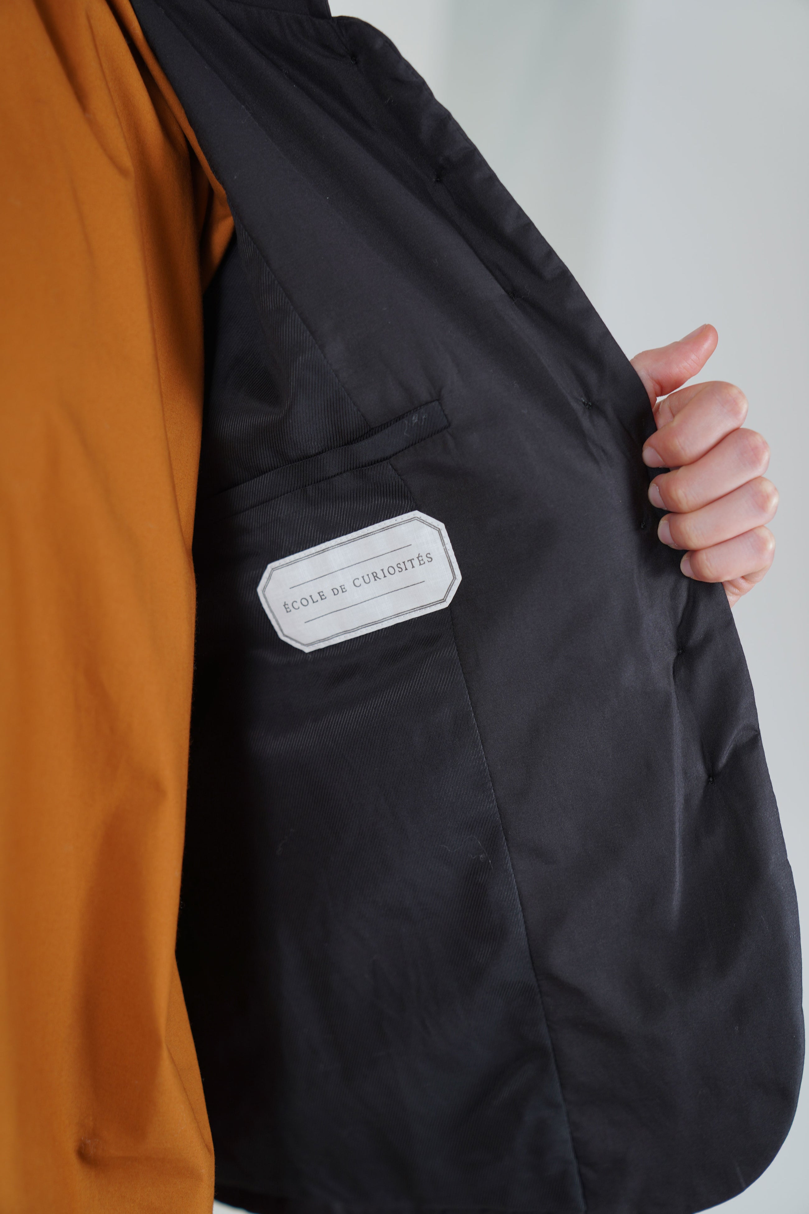 detail view of école de curiosités padded jacket jessica silk cotton black fully lined in soft cotton for added comfort.