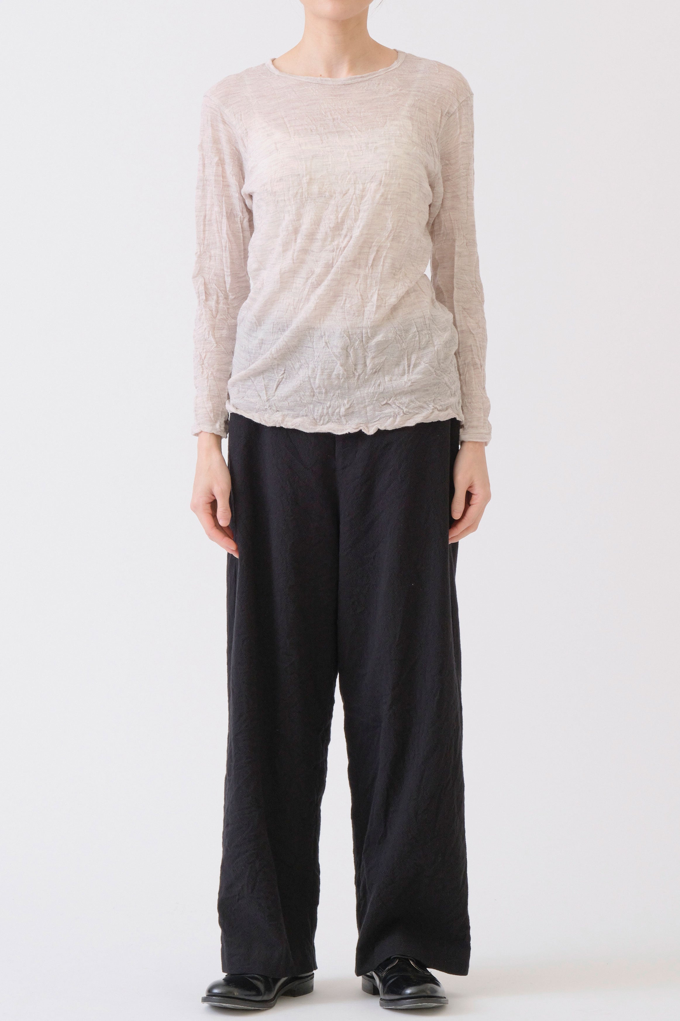 front view of pas de calais wool gauze crinkle pullover ivory paired with long wide trousers