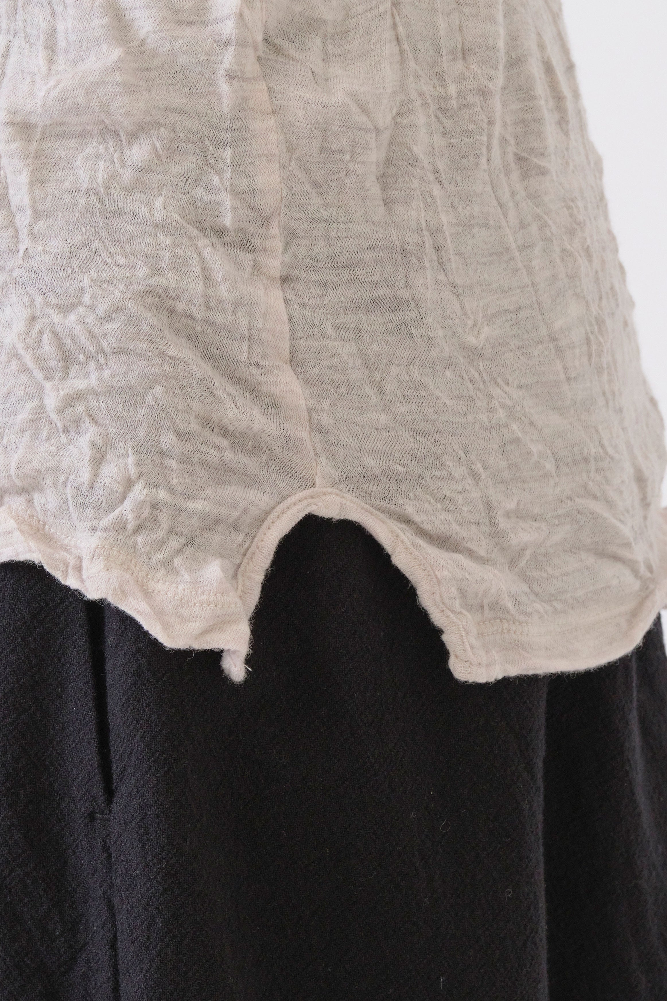 detail view of pas de calais wool gauze crinkle pullover ivory small curved side slit detail