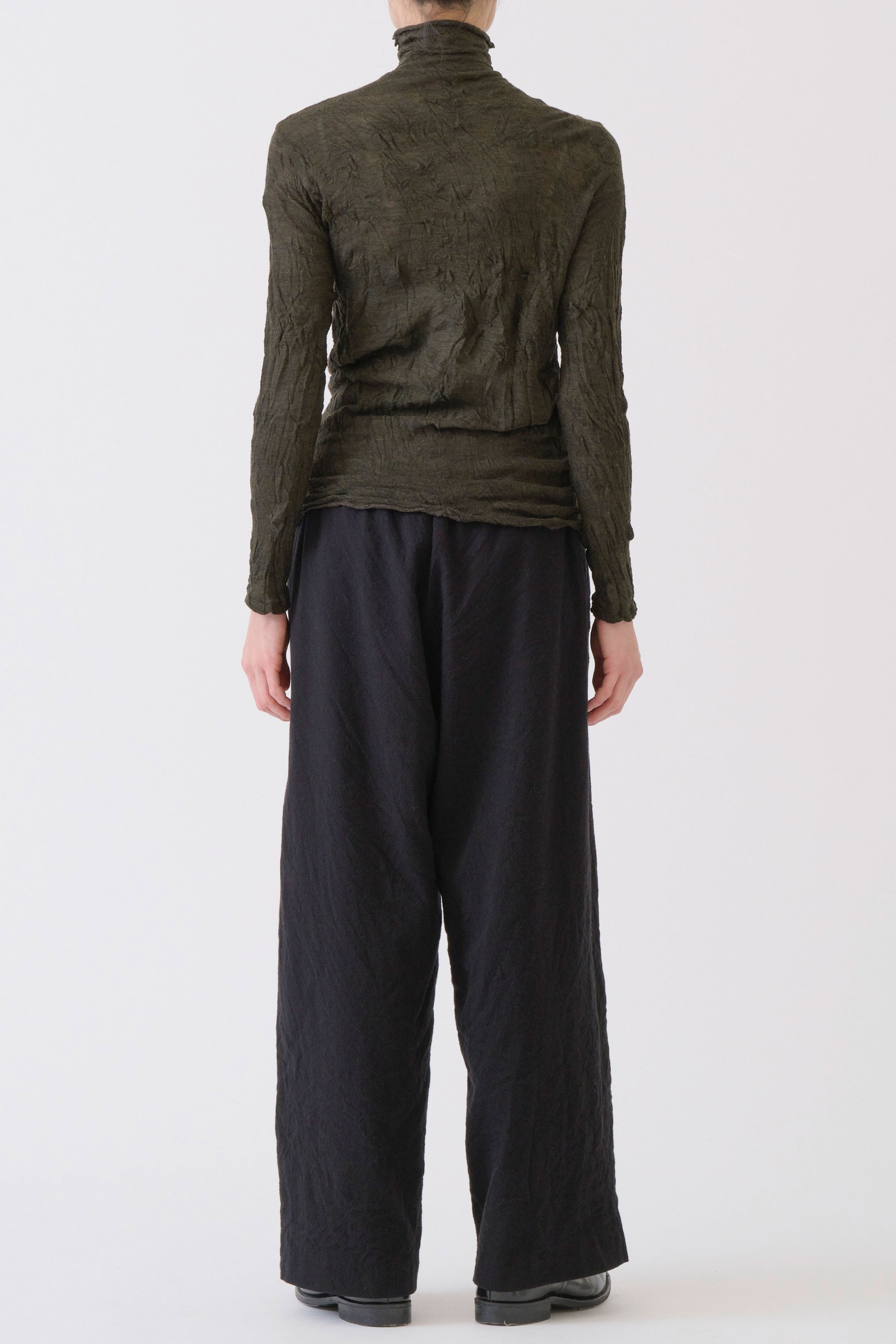 back view of pas de calais wool gauze crinkle turtleneck khaki intentionally crinkled material and relaxed fit.