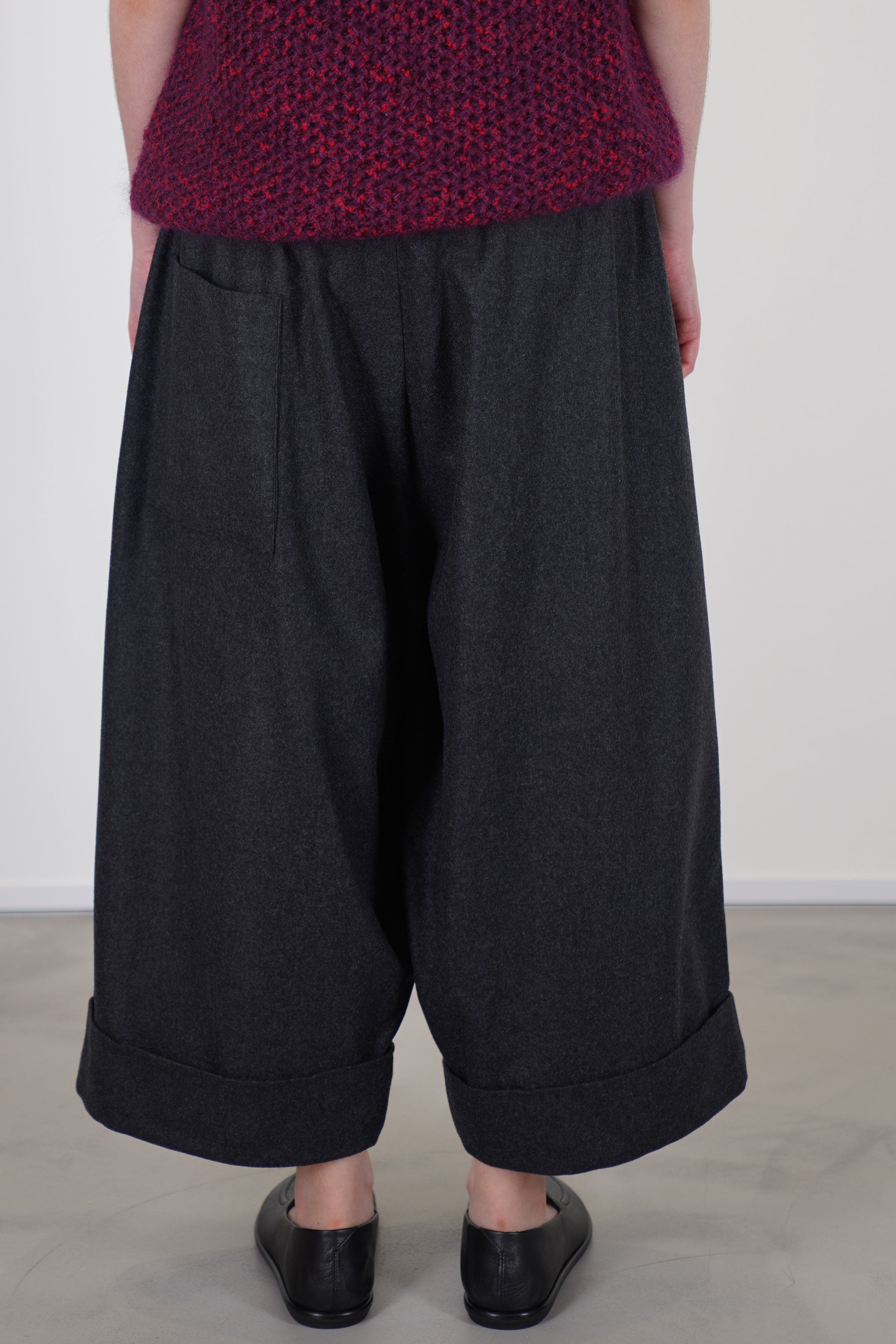 back view of toogood baker trousers wool charcoal they include a low back patch pocket and side pockets for practicality