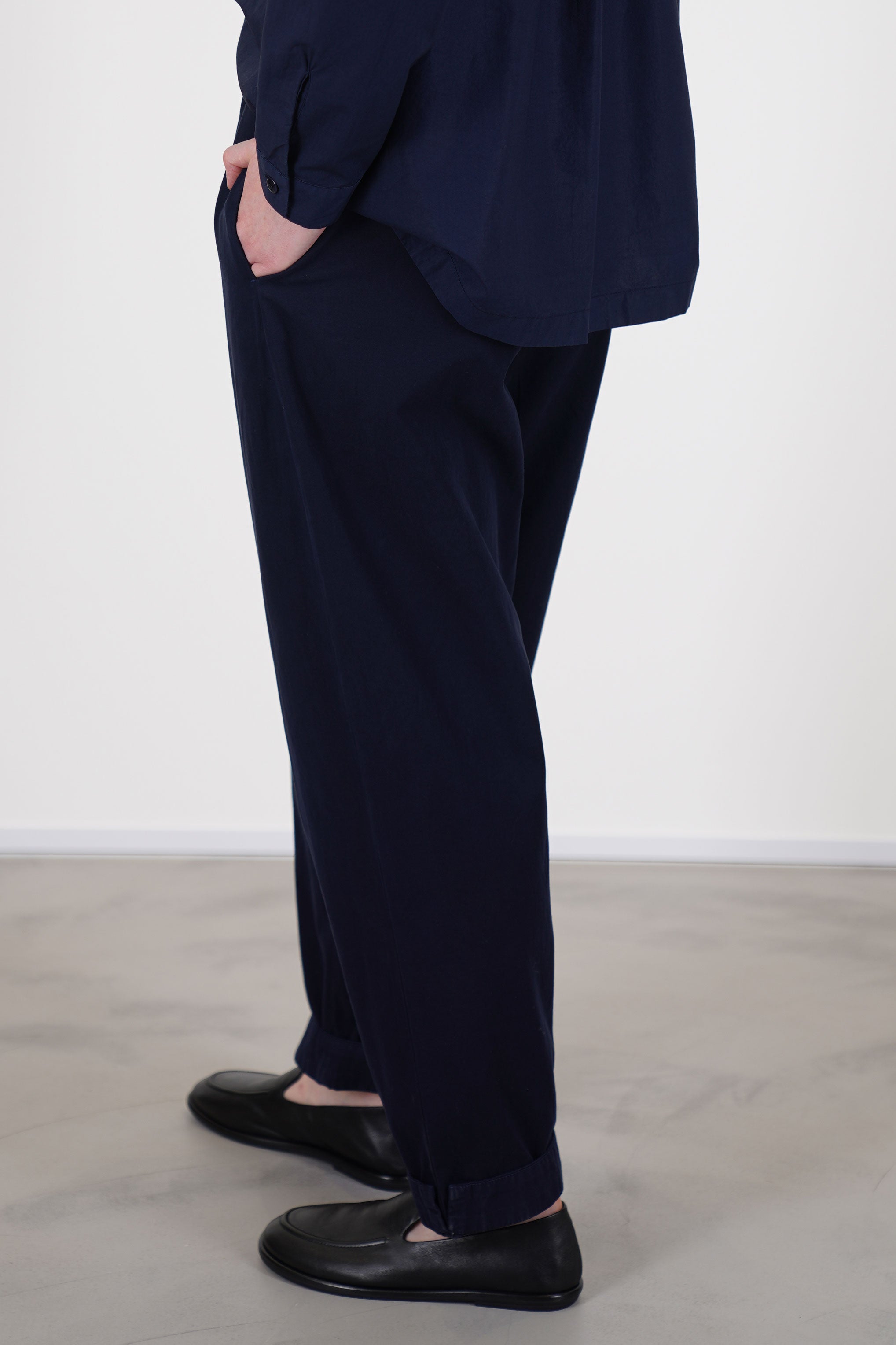 side view of toogood gymast trousers ink side pockets a relaxed fit, crafted from a soft fabric with a gently brushed cotton texture for comfort.