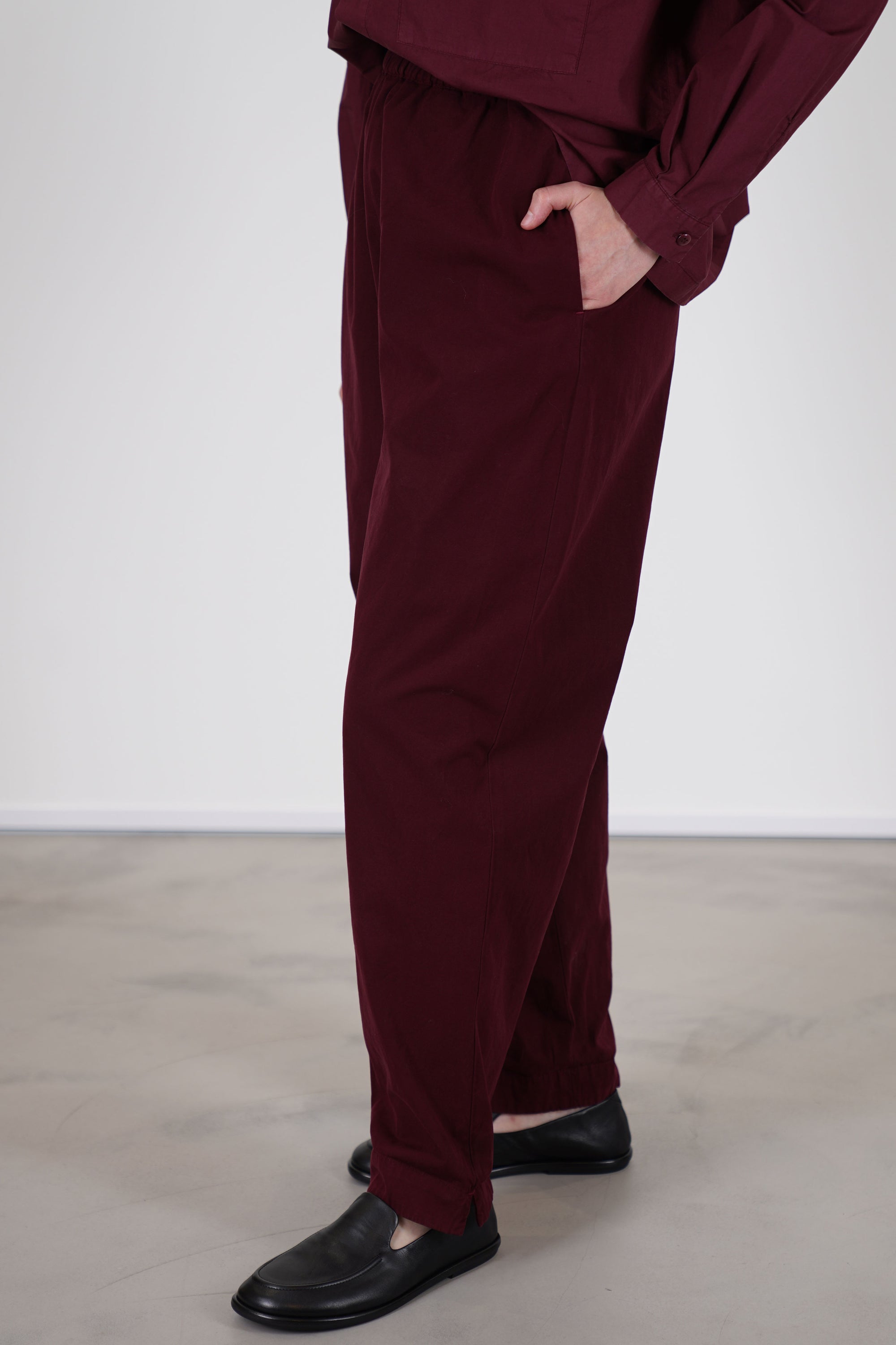 side view of toogood gymast trousers port side pockets and offer a relaxed fit, crafted from a soft fabric with a gently brushed cotton texture for comfort.