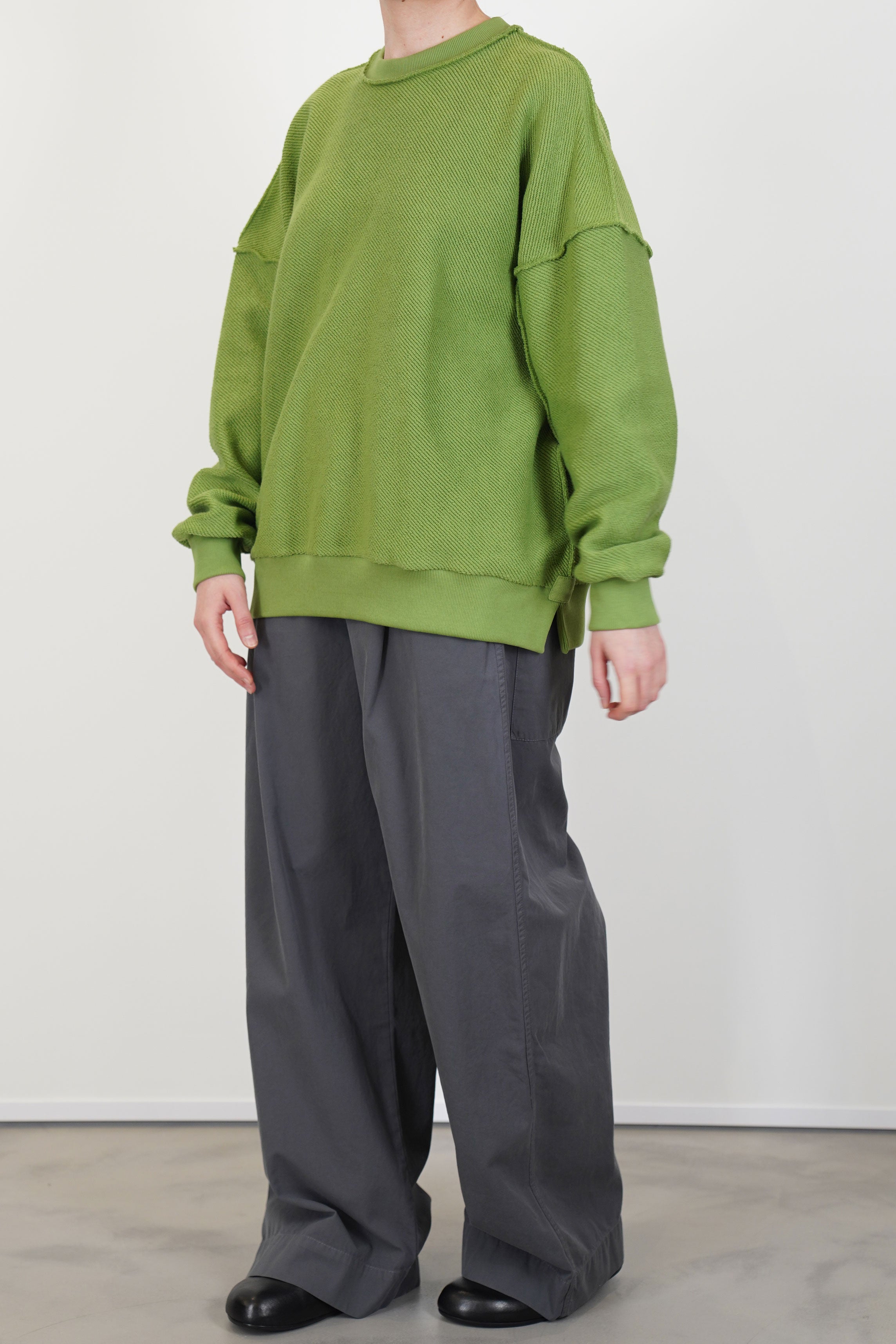 model wearing toogood mechanic jumper loopback twill grass for a structural and relaxed everyday style