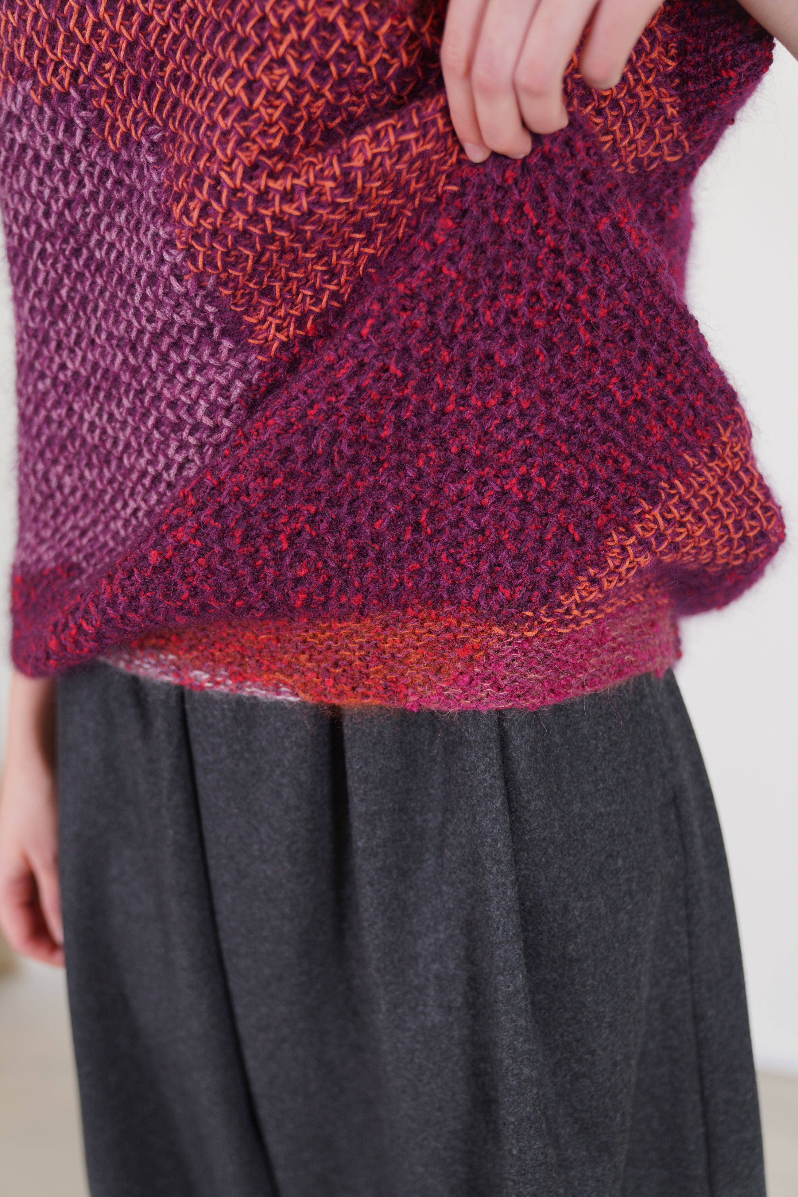 detail view of toogood woolen lotter vest in a honeycomb multi pattern banded detail along the hemline for a refined finish.