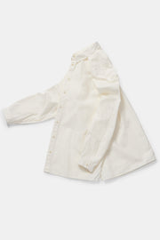 profile view of toogood draughtsman shirt poplin yoghurt  structural design with side slits and tapered sleeves