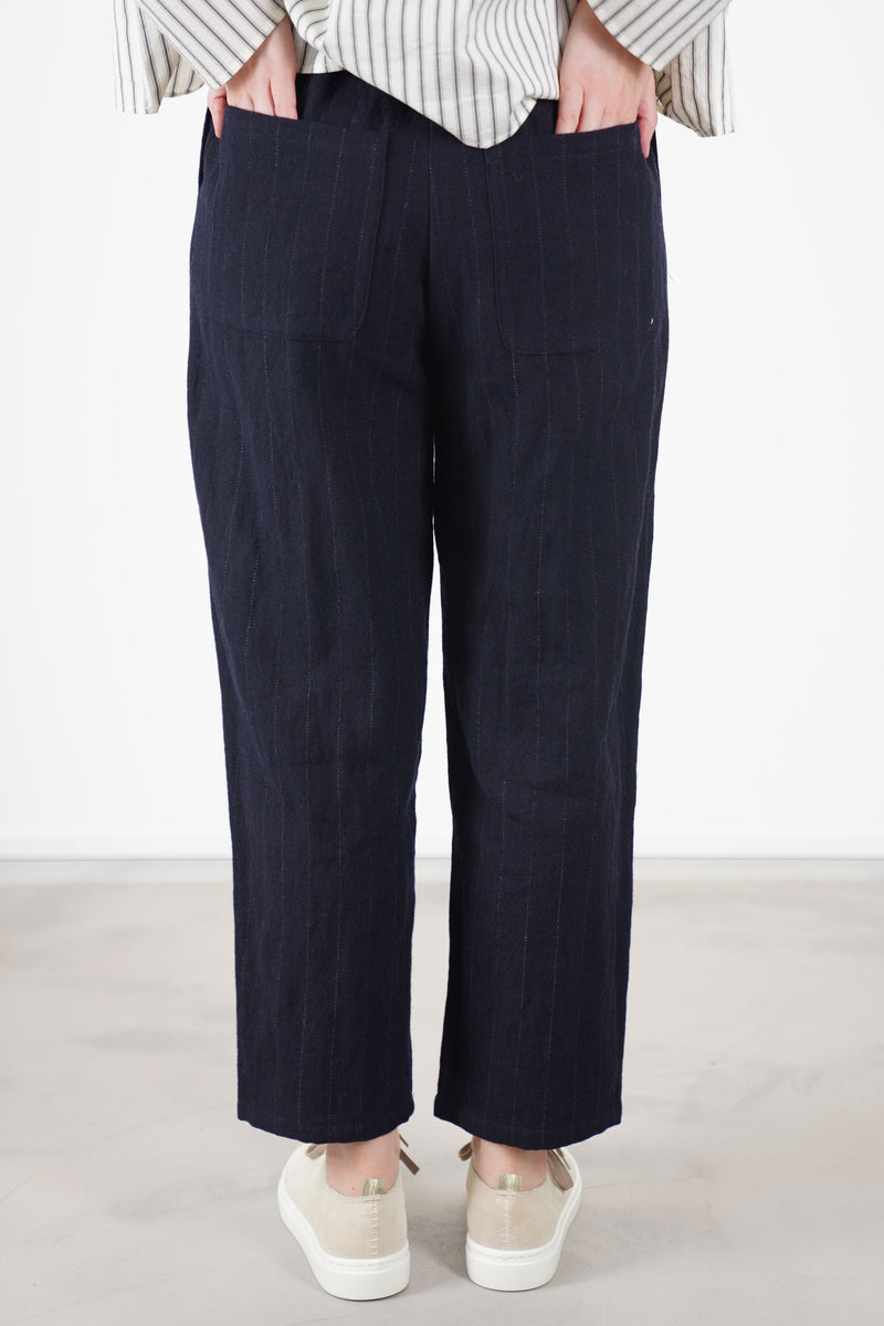 back view of apuntob (a.b) woolen trousers blue thin stripes with two back patch pockets that complete the design for comfort and functionality