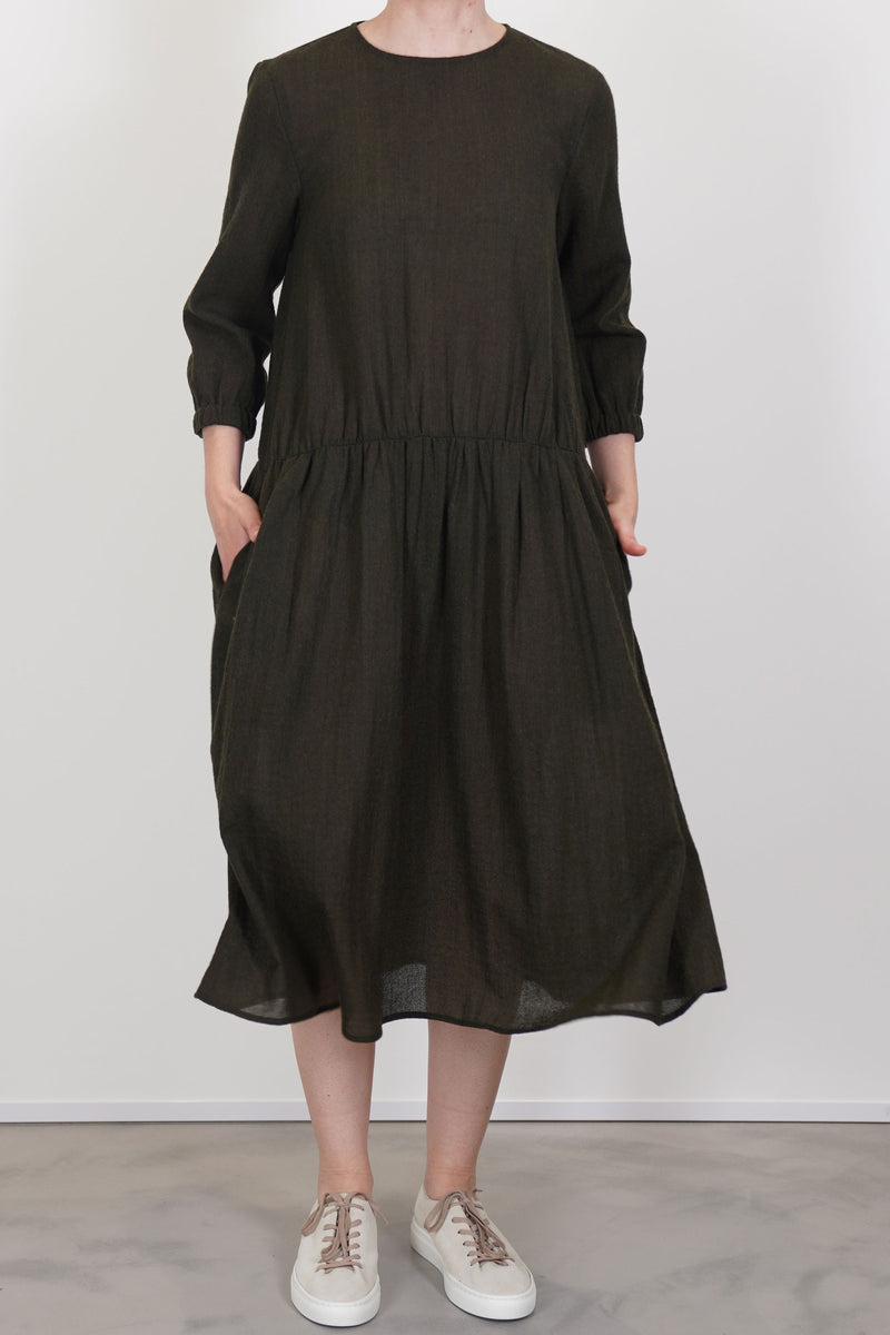 apuntob (a.b) wool dress in military green crafted in lightweight virgin wool fleece. 
