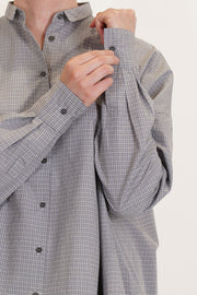 detail view of apuntob (a.b) wide shirt gray check gathered material at the cuffs and a button opening at the cuffs