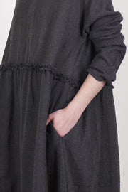 detail view of apuntob (a.b) dress wool asphalt grey ruffle band detail at the waist thatadds a subtle, elegant touch and practical side pockets