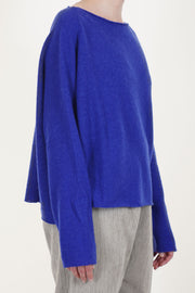 side view of apuntob (a.b) wool silk knitwear electric blue featuring a flattering boat neckline and long slim fitted sleeves