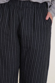 detail view of apuntob (a.b) trousers stripes black elasticated waistband, side pockets.