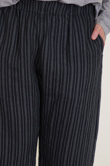 detail view of apuntob (a.b) trousers stripes black elasticated waistband, side pockets.