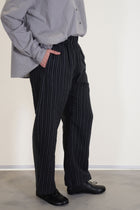 side view of apuntob (a.b) trousers stripes black relaxed fit, long curved leg