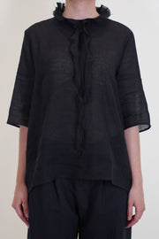 apuntob (a.b) shirt black featuring ruffle details at the neckline, elbow length slim sleeves and a fitted cut on the shoulders.