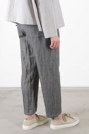 back view of apuntob (a.b) woolen trousers ecru stone relaxed fit with a tapered leg, and a slightly cropped length.