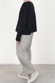 side view of apuntob (a.b) trousers cord ecru featuring a curved leg detail that enhances movement and style