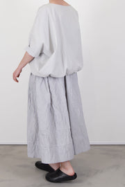 back view of apuntob (a.b) skirt fine stripes abyss midi length and fluid movemnts