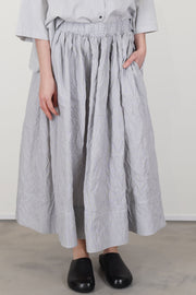 model wearing apuntob (a.b) skirt fine stripes abyss