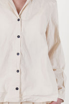 bergfabel jenny shirt off-white features a v-neckline accented by a notched collar detail.