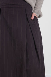 detail view of bergfabel emma skirt eggplant wide pleated accents and practical pockets.