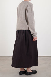 back view of bergfabel emma skirt eggplant fewturing subtle thin pinstripes and a midi length