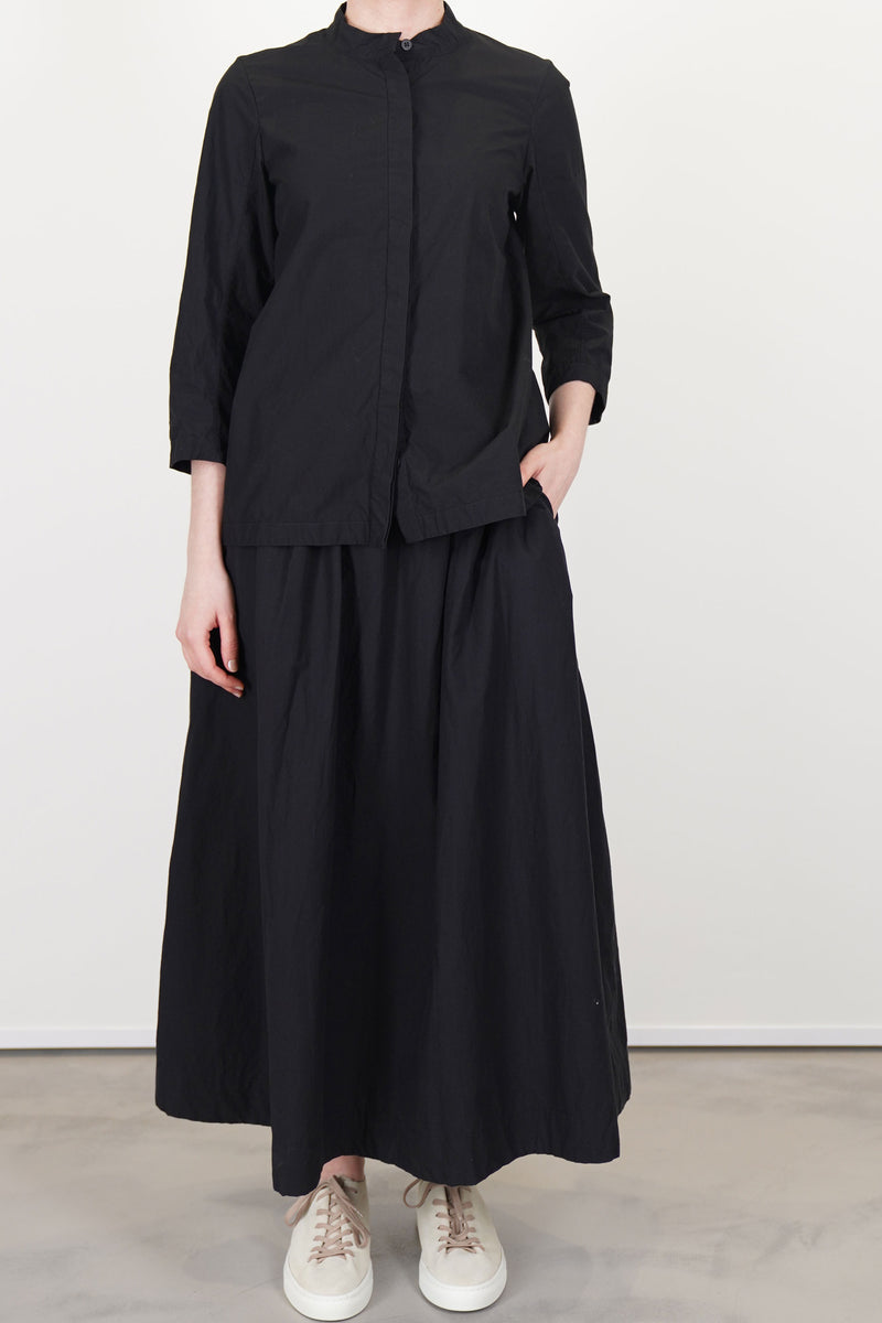 model wearing bergfabel ada shirt black with matching skirt for an effortless and elegant everyday look