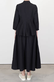 back view of bergfabel ada shirt black worn with matching skirt accentuating the understated minimalist design